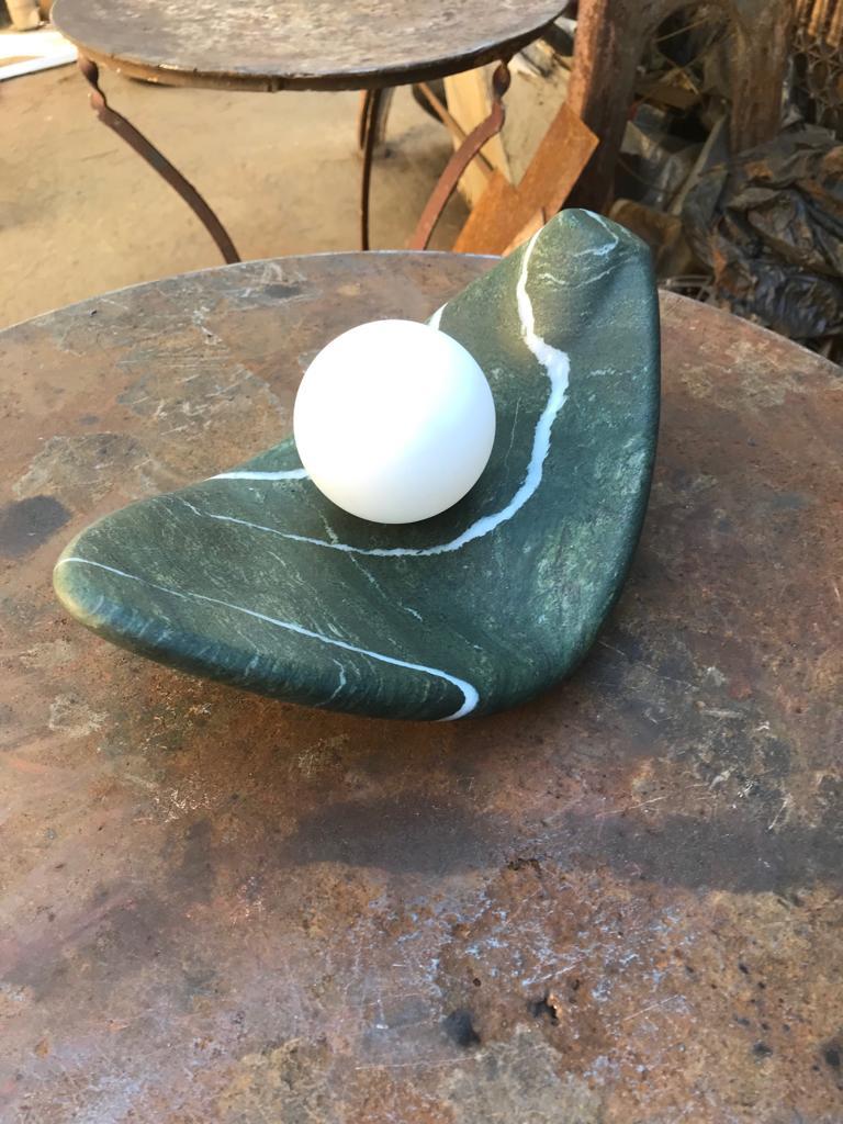 Prickless Pearl - 01 Sculpture Table Lamp by ON.ENTROPY
Dimensions: W 30 x D 14 x H 10 cm
Materials: Green Marble.

on• entropy is a marble atelier established in 2009 in Athens and London with a focus on metamorphosis. Expanding from object to