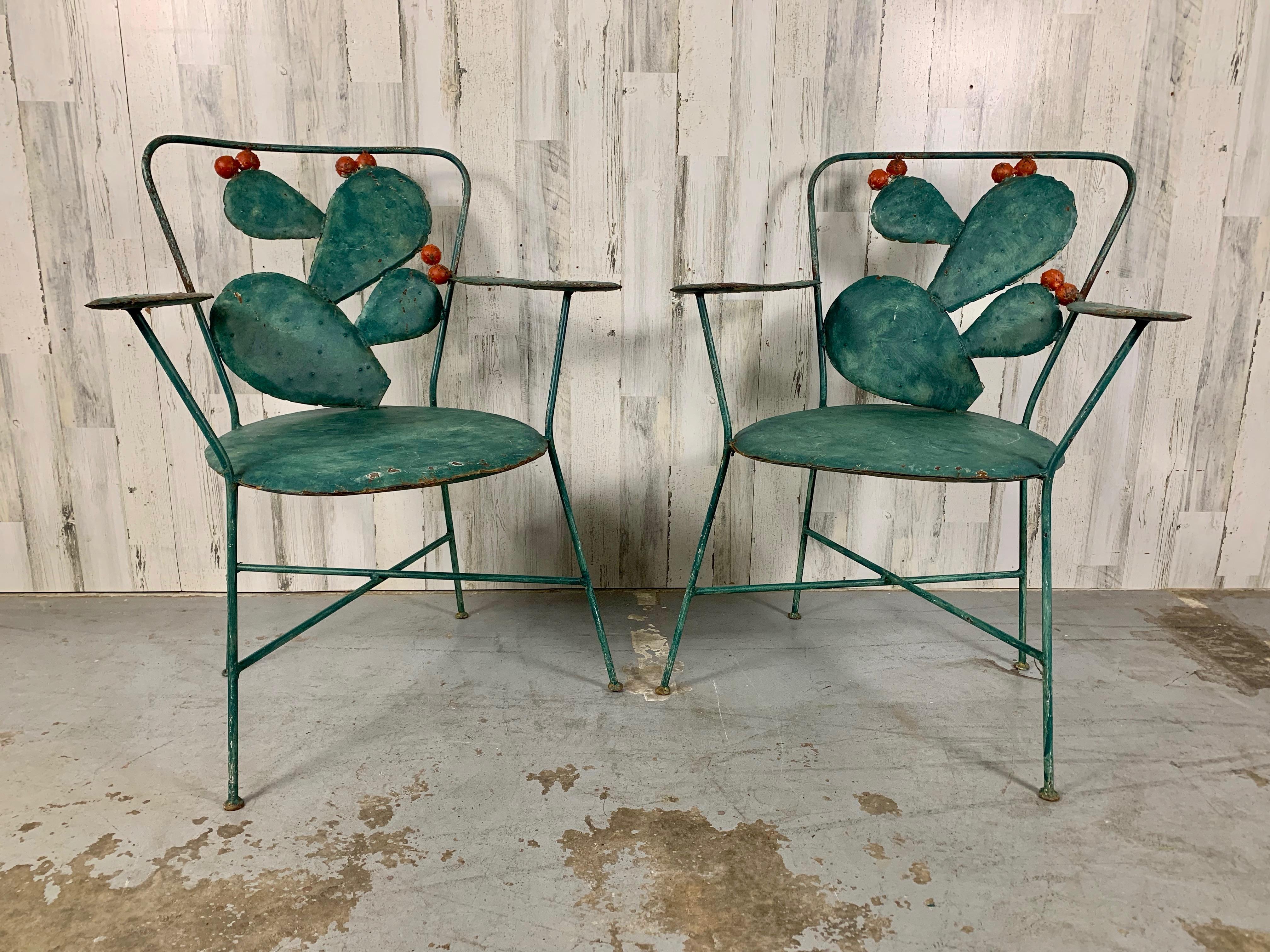 Abstract Cactus with flower buds patio chairs. Folk art for the garden or in the sunroom, Mid century styling with X base stretcher sold as a pair.