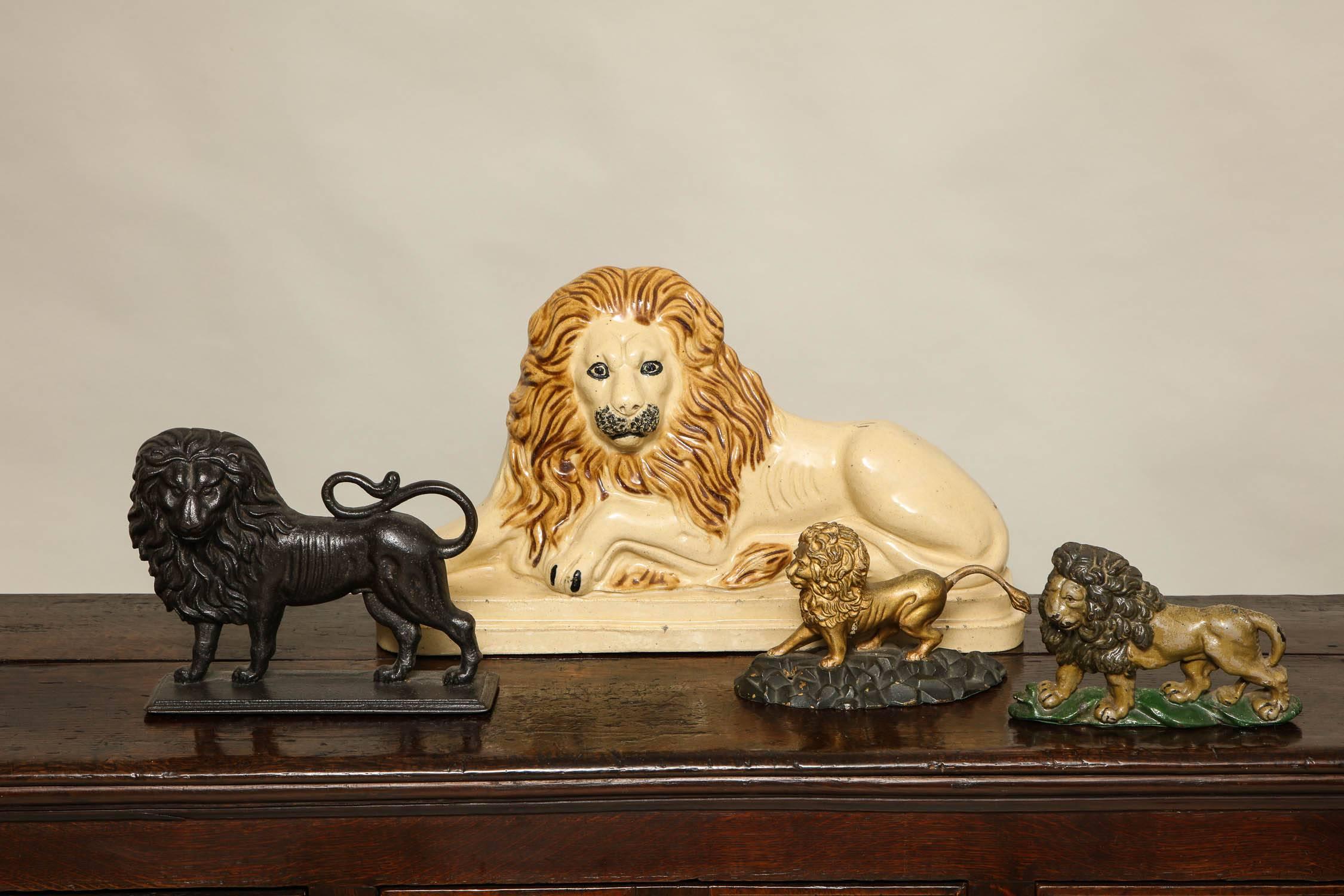 A collection of four lions:

Smallest:
Painted tan and brown lion
English cast iron lion doorstop retaining original tan and brown paint, probably Coalbrookdale, circa 1880
Measures: 8 in. high x 9 in. long x 1 in. deep
$750

Next