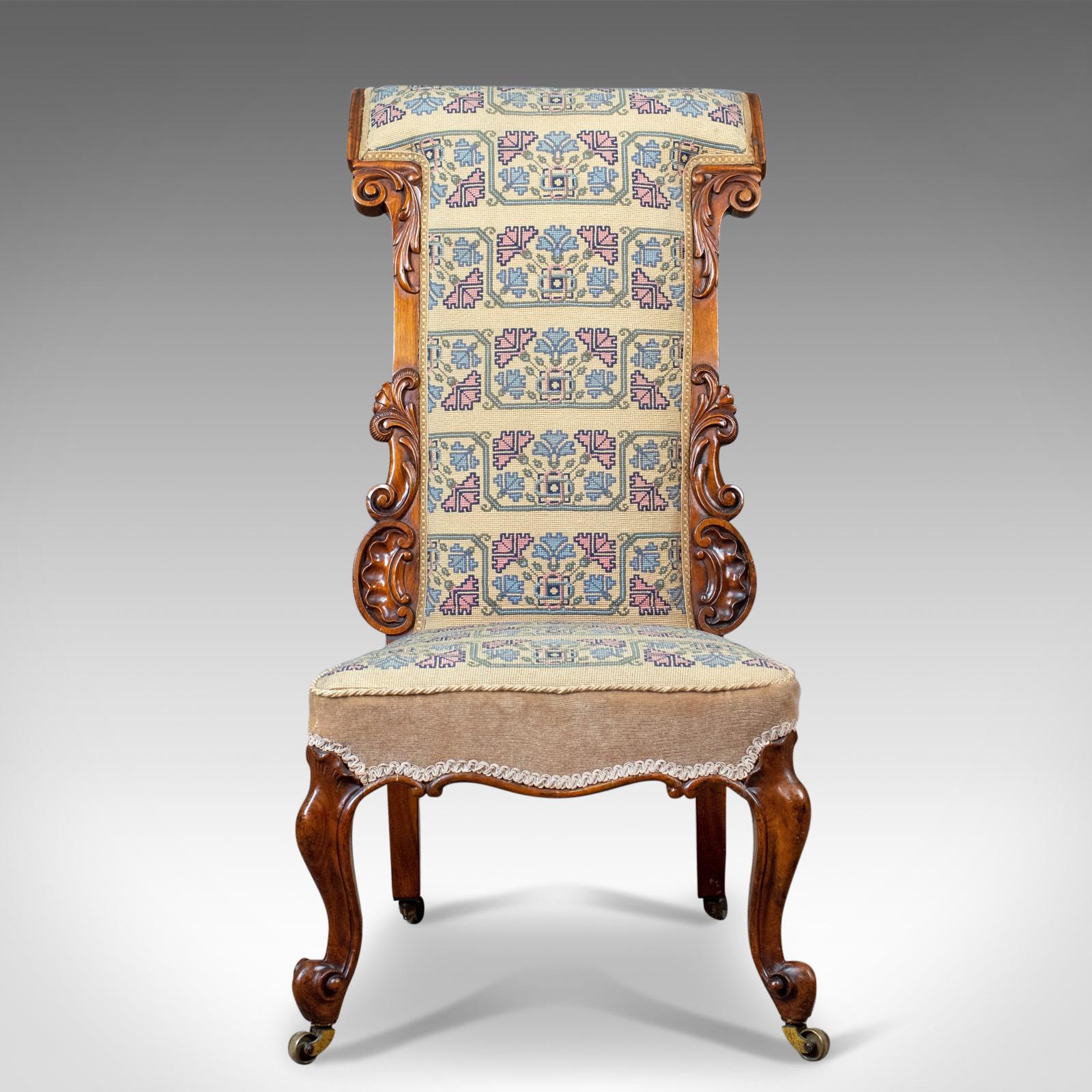 This is an antique prie dieu chair, a 19th century, early Victorian chair in walnut with a needlepoint tapestry seat cover. Ideal as a bedroom side chair and dating to circa 1840. 

The walnut displaying good color and grain interest
Raised upon