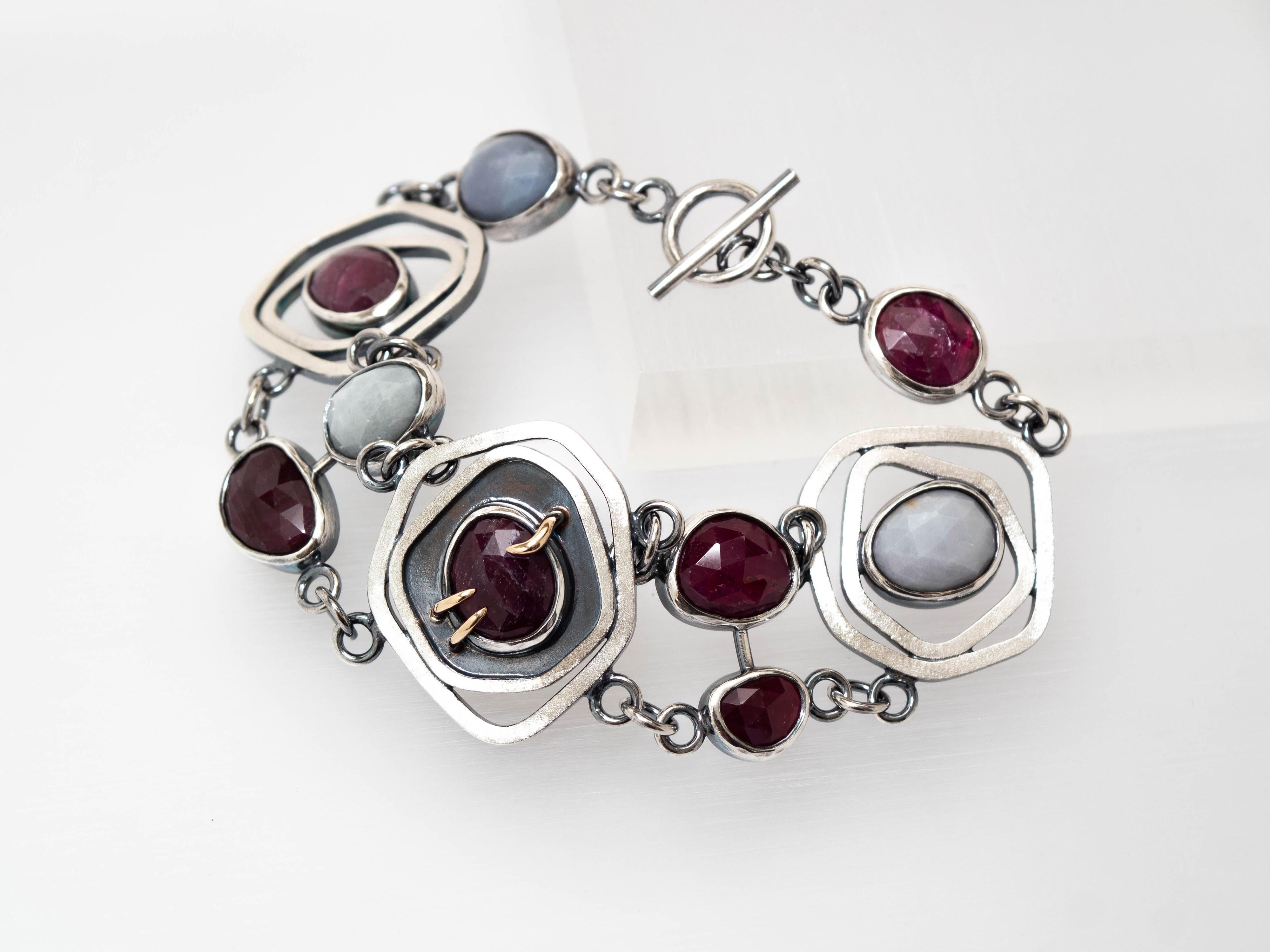 Priestess Ruby Sapphire 14K Sterling Silver Bracelet by TIN HAUS.

The essence of the Priestess Bracelet was inspired by the High Priestess tarot card. The High Priestess is a card of mystery, divinity, contemplation, and stillness that suggests