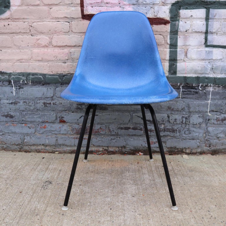 Four vintage Herman Miller Eames fiberglass chairs in primary colors. All chairs in very good vintage condition with Herman Miller bases available in black or metallic silver color finish. All glides intact. No cracks to shells. All new shock