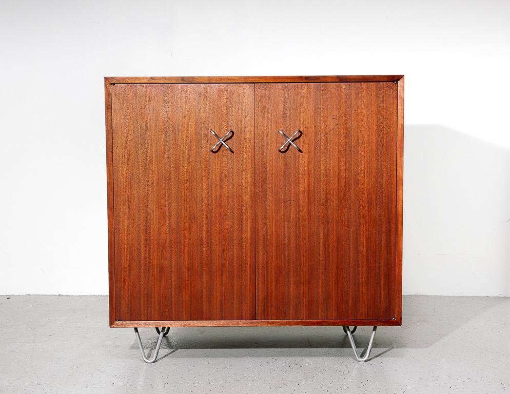 Primavera cabinet designed by George Nelson for Herman Miller. Mahogany cabinetry with zinc-plated X-pulls and hairpin legs.