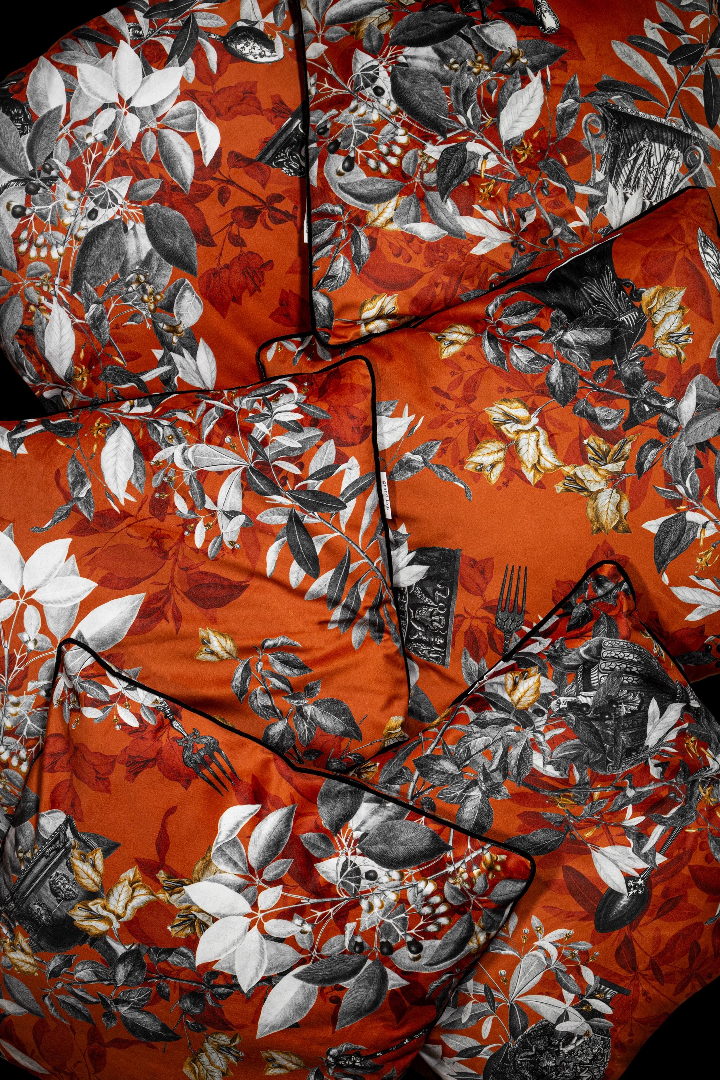 Primavera Romana pillows is a set of cushions inspired by those beautiful Italian spring days in Rome. Vibrant orange background, black and white leaves, ancient amphorae, detailed vintage cutlery and yellow flowers are merged together in a dynamic