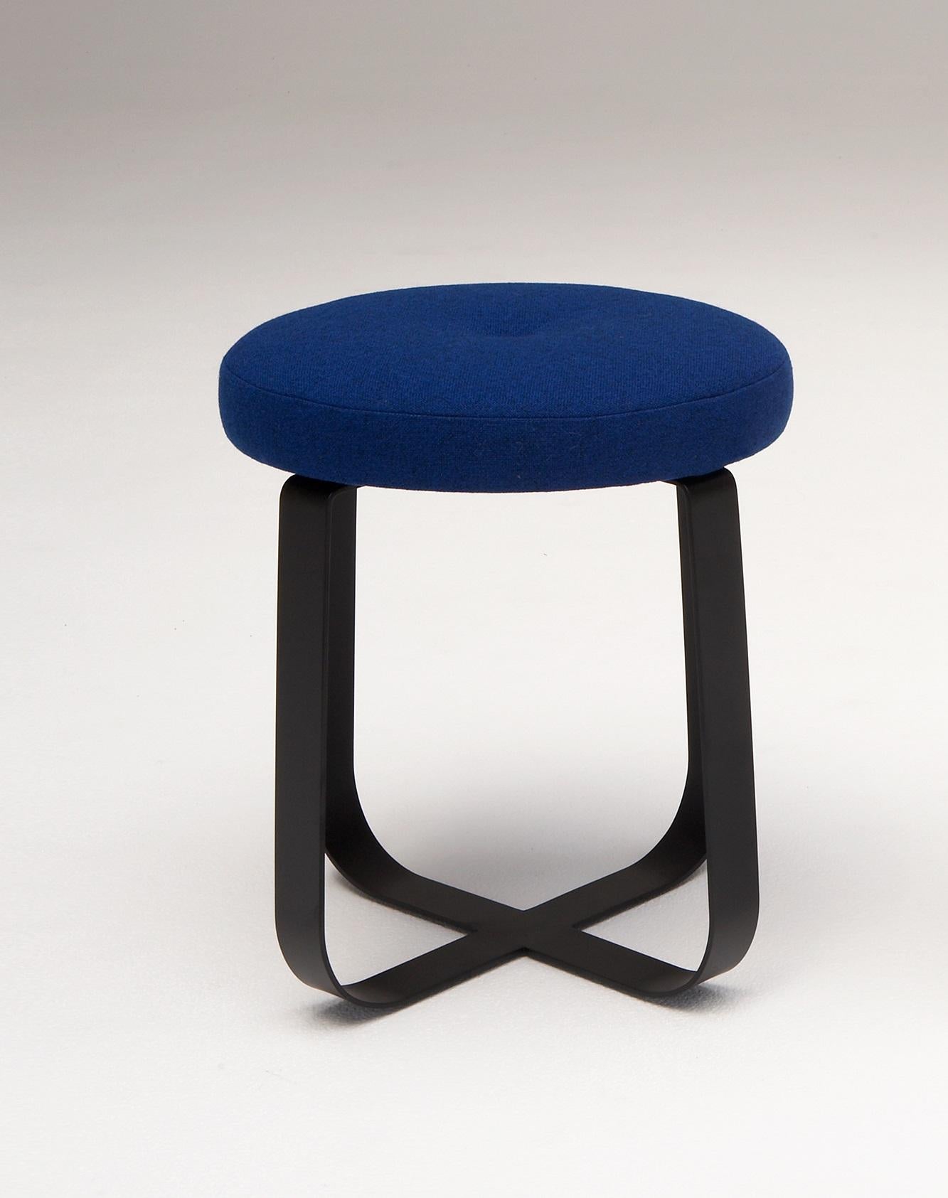 Primi Low Stool by Phase Design
Dimensions: Ø 48.3 x H 45.7 cm. 
Materials: Powder-coated steel and upholstery.

Solid steel flat bar available in a flat black or white powder coat finish with CNC cut walnut, white ash, or upholstered top. Powder