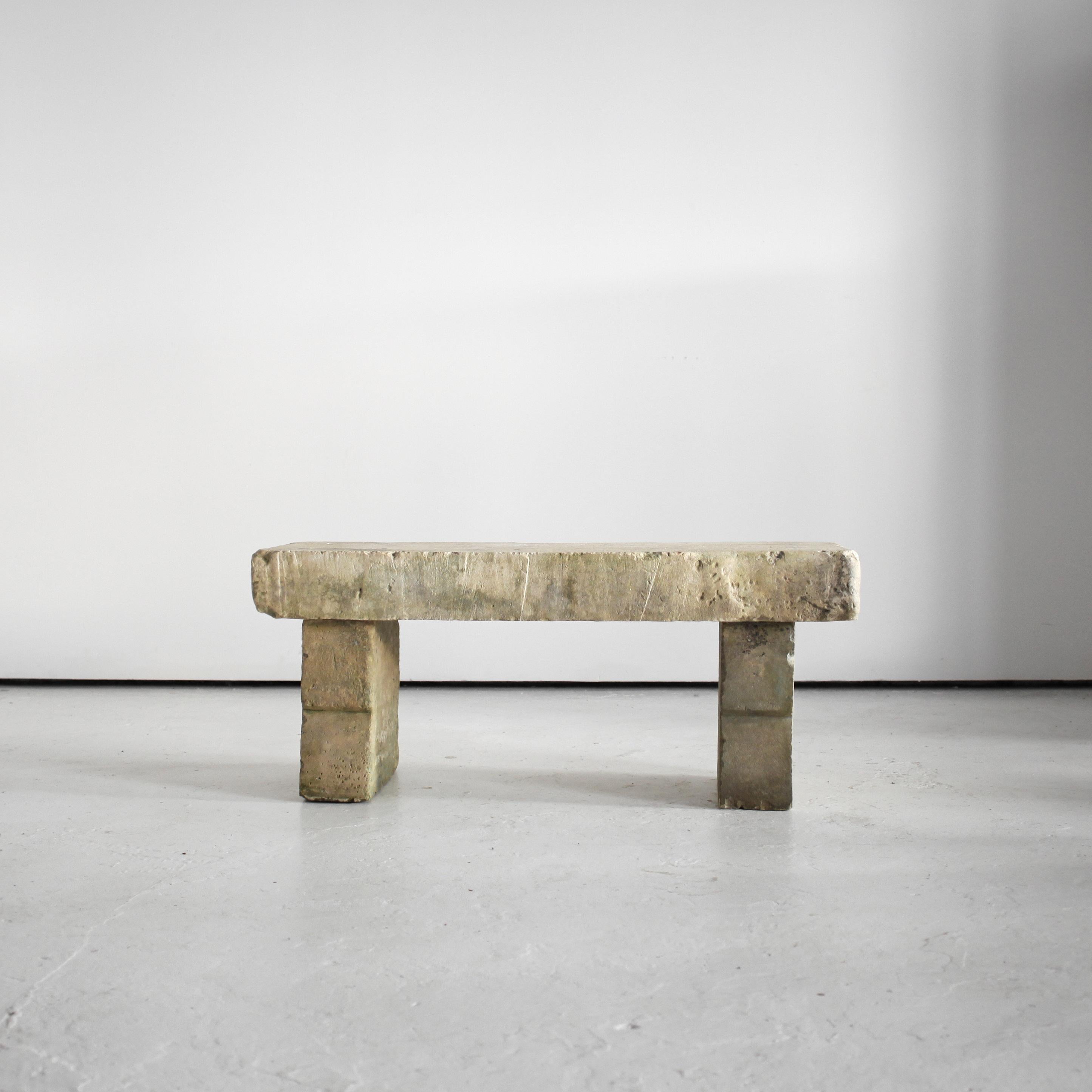 A French primitively carved “tuffeau” stone bench from the Loire valley.

Constructed simply from three thick slabs of local Loire stone with stepped detail to the two legs.