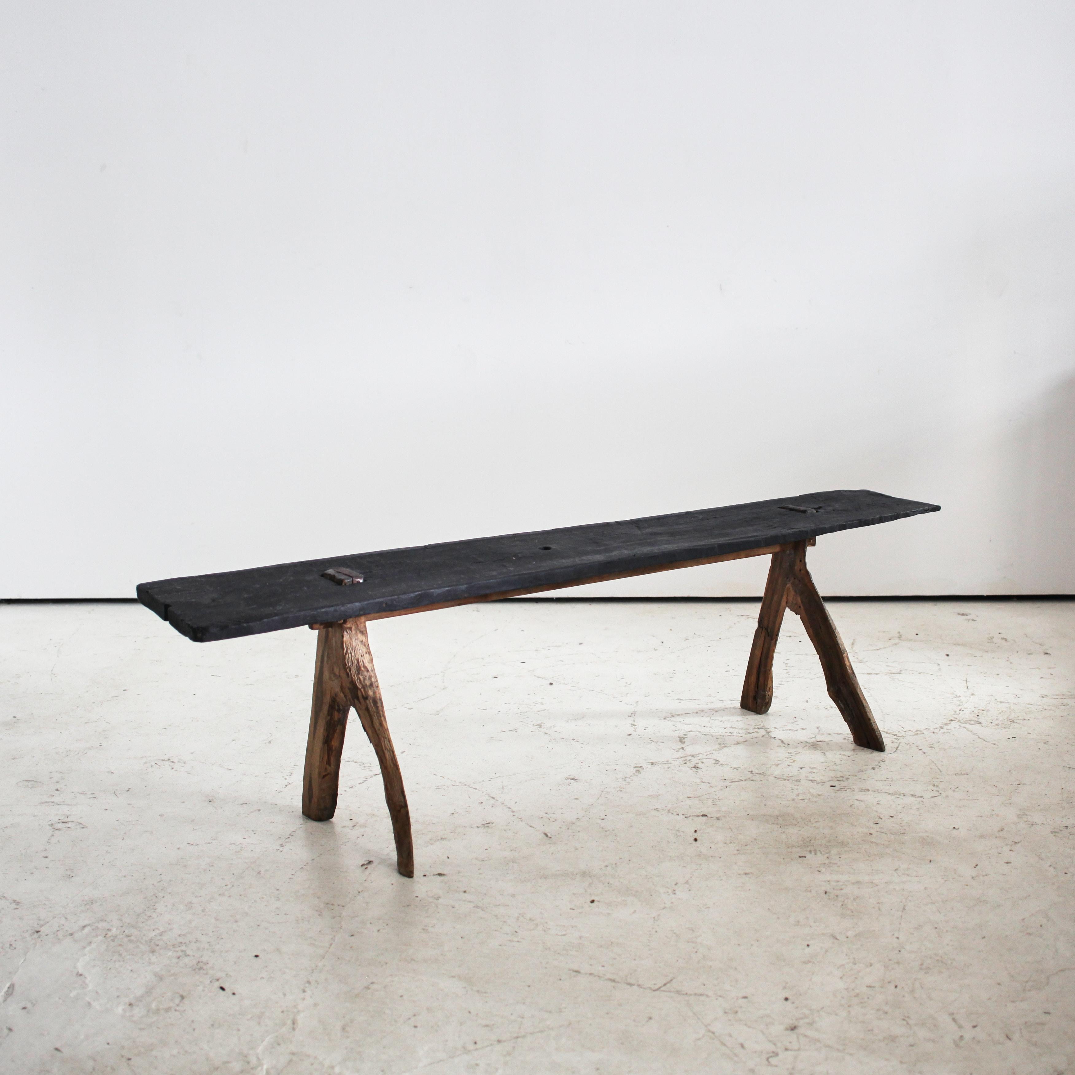 A primitive Meiji period Japanese Long Bench.

Charred beech top on “wishbone” cedar legs.