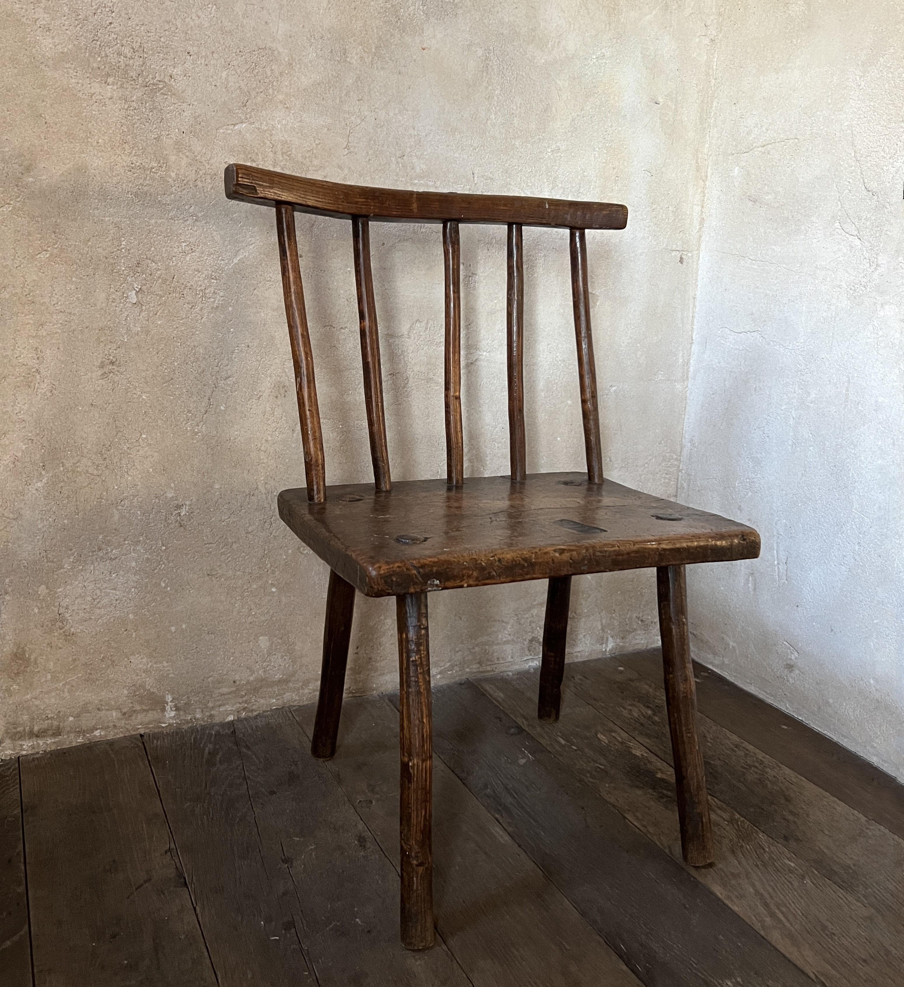 A verry original 19th century Welsh stick back chair. Made from elm with a solid one slab seat. Beautiful patina, primitive organic look but sturdy and ready for everyday use. 