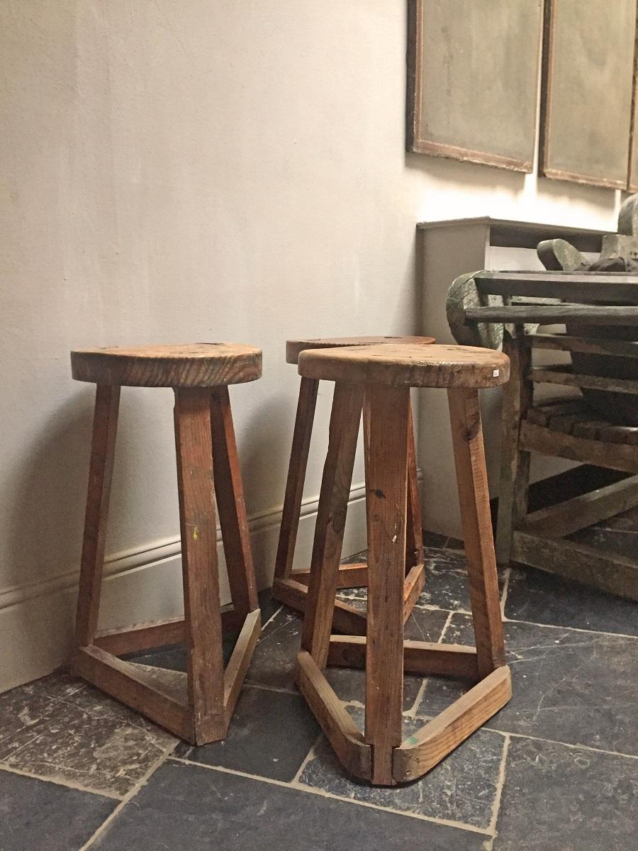 Set of 3 pine three-legged stools. Dating from the late 19th century these type of stools were made since the middleages and never changed much. Practical, strong and easy to look at these seats or side tables still are very usable in every home.