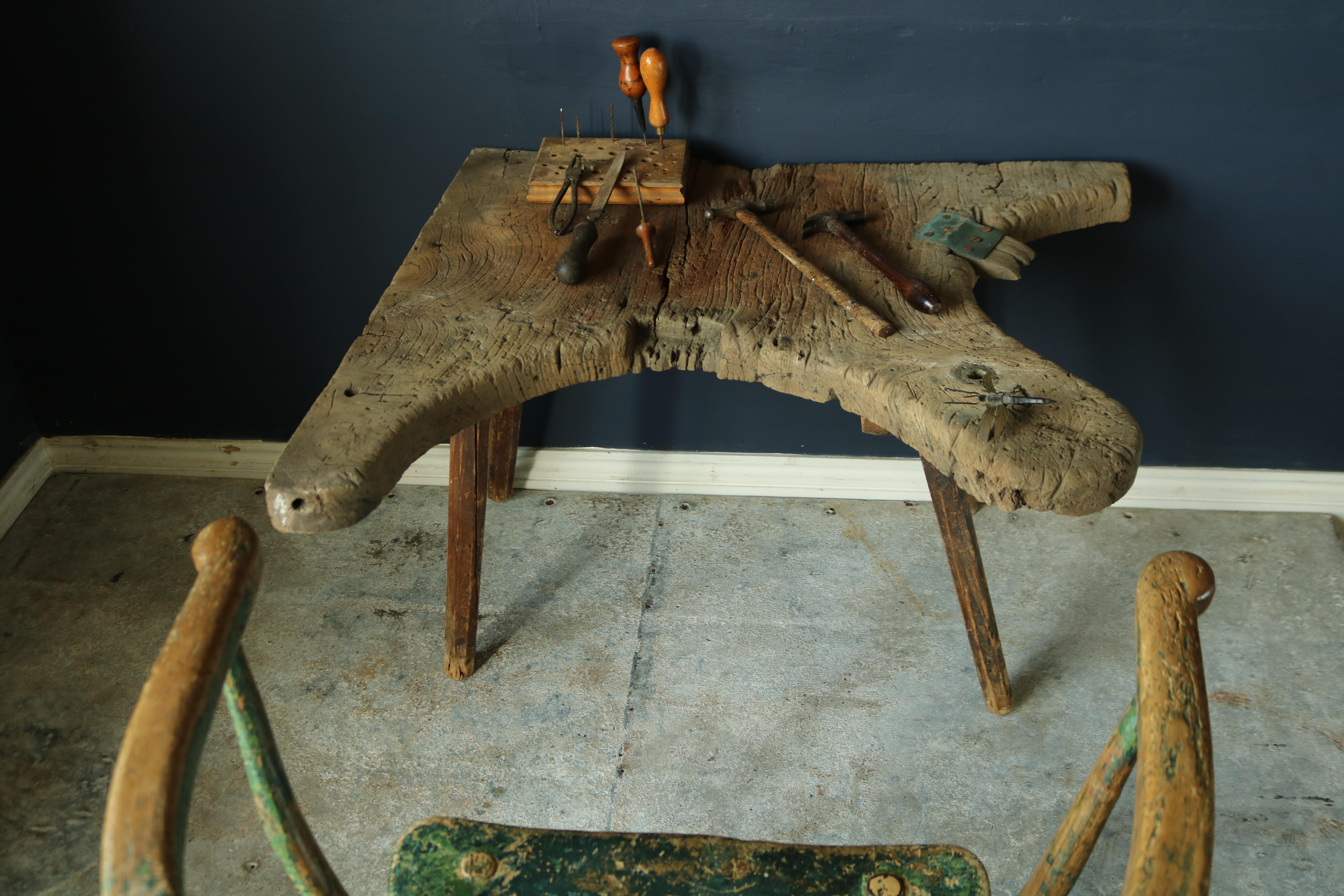 A wonderful Primitive early 19th century jewelry makers work bench, fantastic wear and patina, stand on four Primitive stick legs.