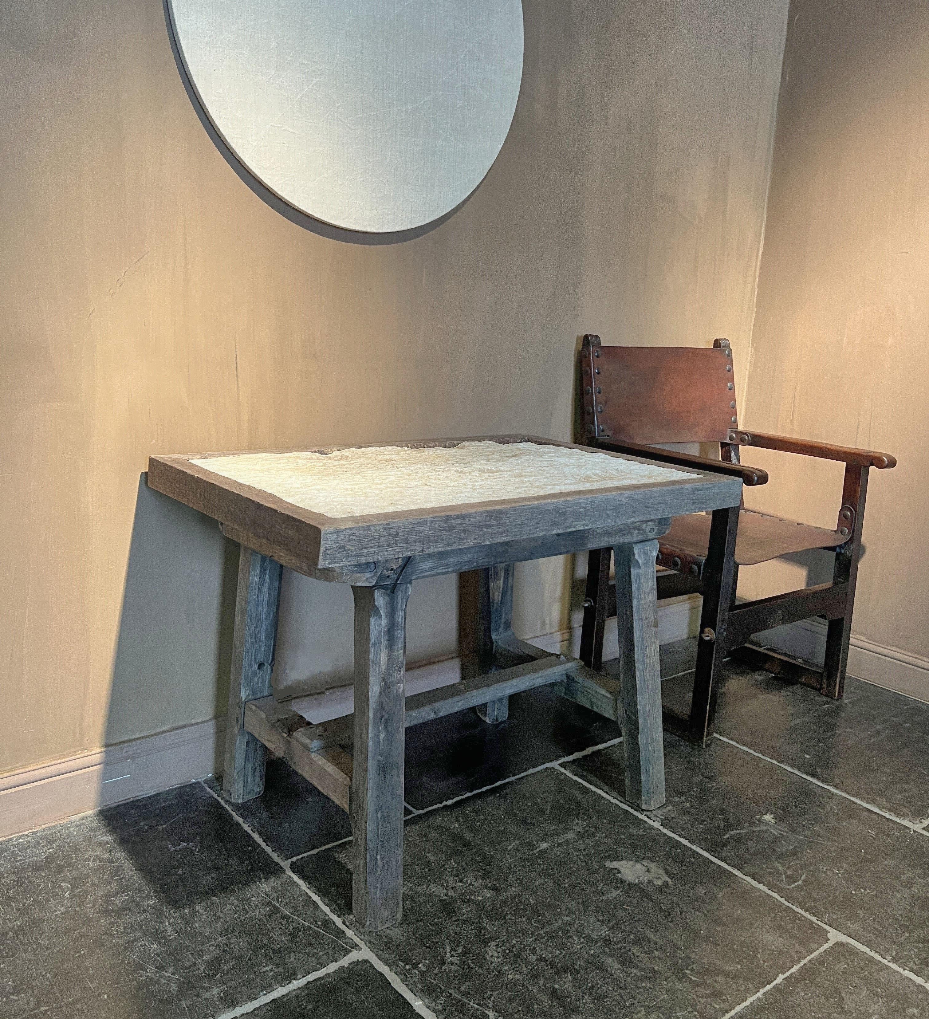 Honest and pure table made in the 19th century from oak and stone. The design reflecting a practical use as a sculpture or rent table but with great proportions. Overall a very attractive patina with the top stone beautifully worn.