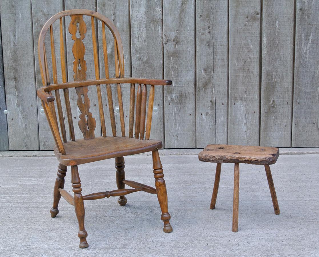 From an Irish farmhouse, a good, early and substantial Windsor chair.

Provincially made and primitive in design, the yew wood splat of a charming simplified pierced form, the back hoop and arm bow in yew wood also. With ring turned legs to front