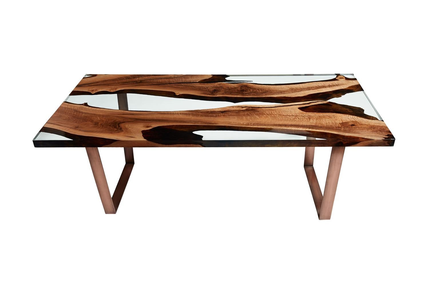 The ‘Primitive 220 Resin Dining Table’ was made in Ankara, Turkey with walnut wood. The wood is kilned and dried prior to being filled with high quality resin and has cast iron geometric legs. Its edges are straight cut to show the depth of the wood
