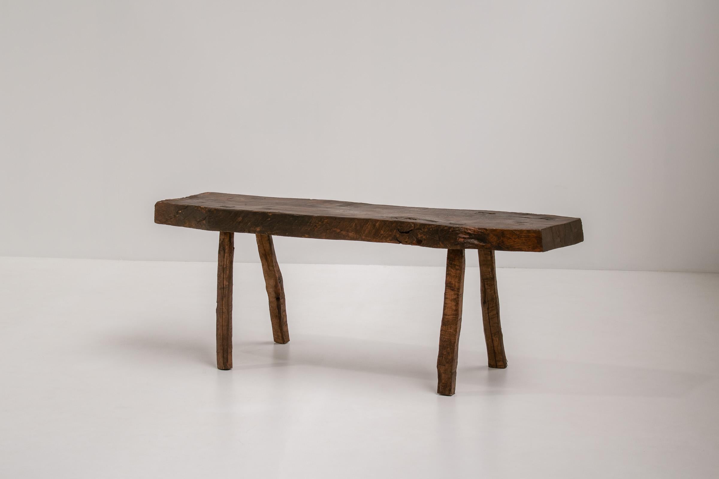 A stunning and unique beautifully weathered rustic wabi-sabi side table or bench. Sourced from the picturesque landscapes of Southern France. Its natural patina and textured surface create a harmonious balance between raw simplicity and refined