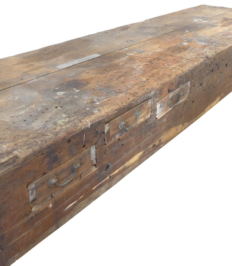 A warm and textured workbench with wear fitting and appropriate to its age, to add a rustic touch to your home or office. Built in storage add a wonderfully utilitarian and versatile touch to this elegantly worn momentally scaled, eye catching piece.