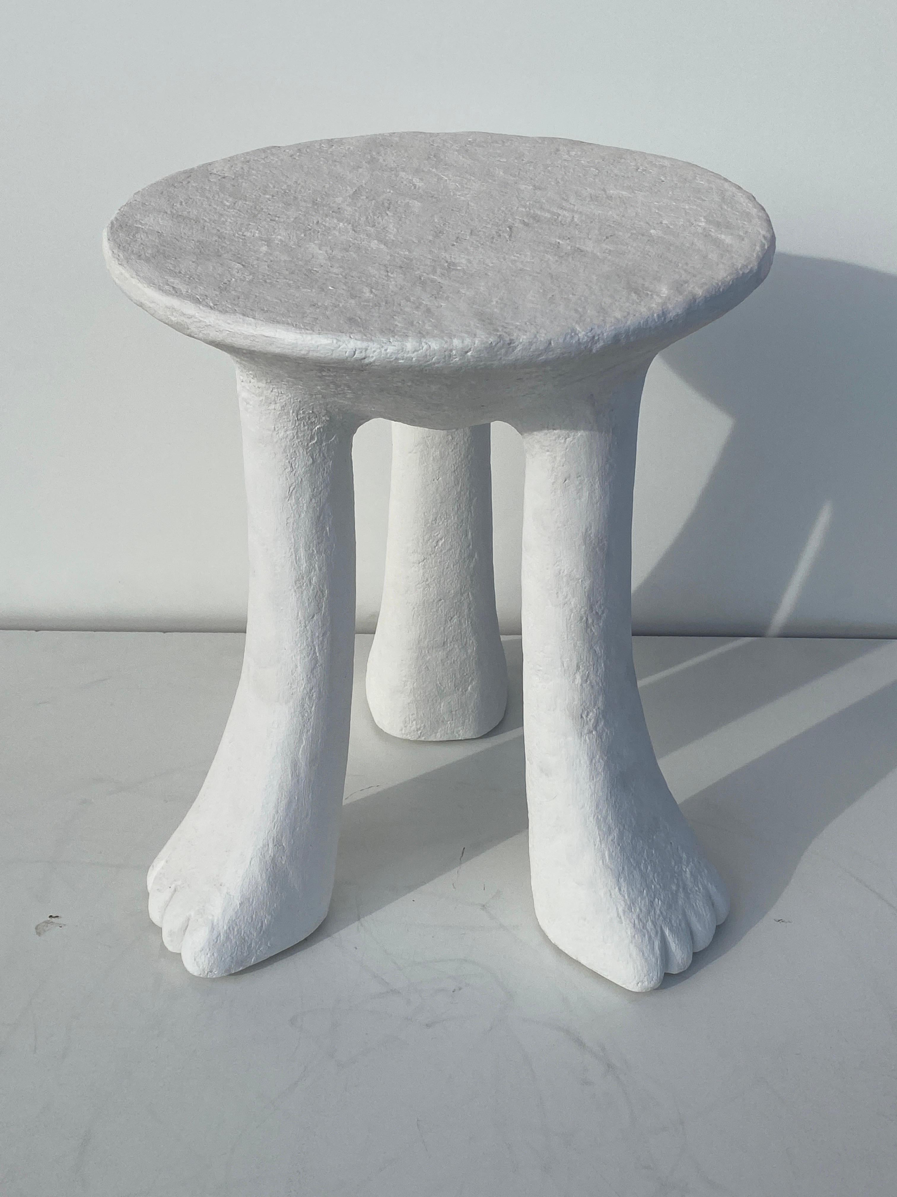 Primitive “African” side / end table in the style of John Dickinson made of wood and covered in plaster.