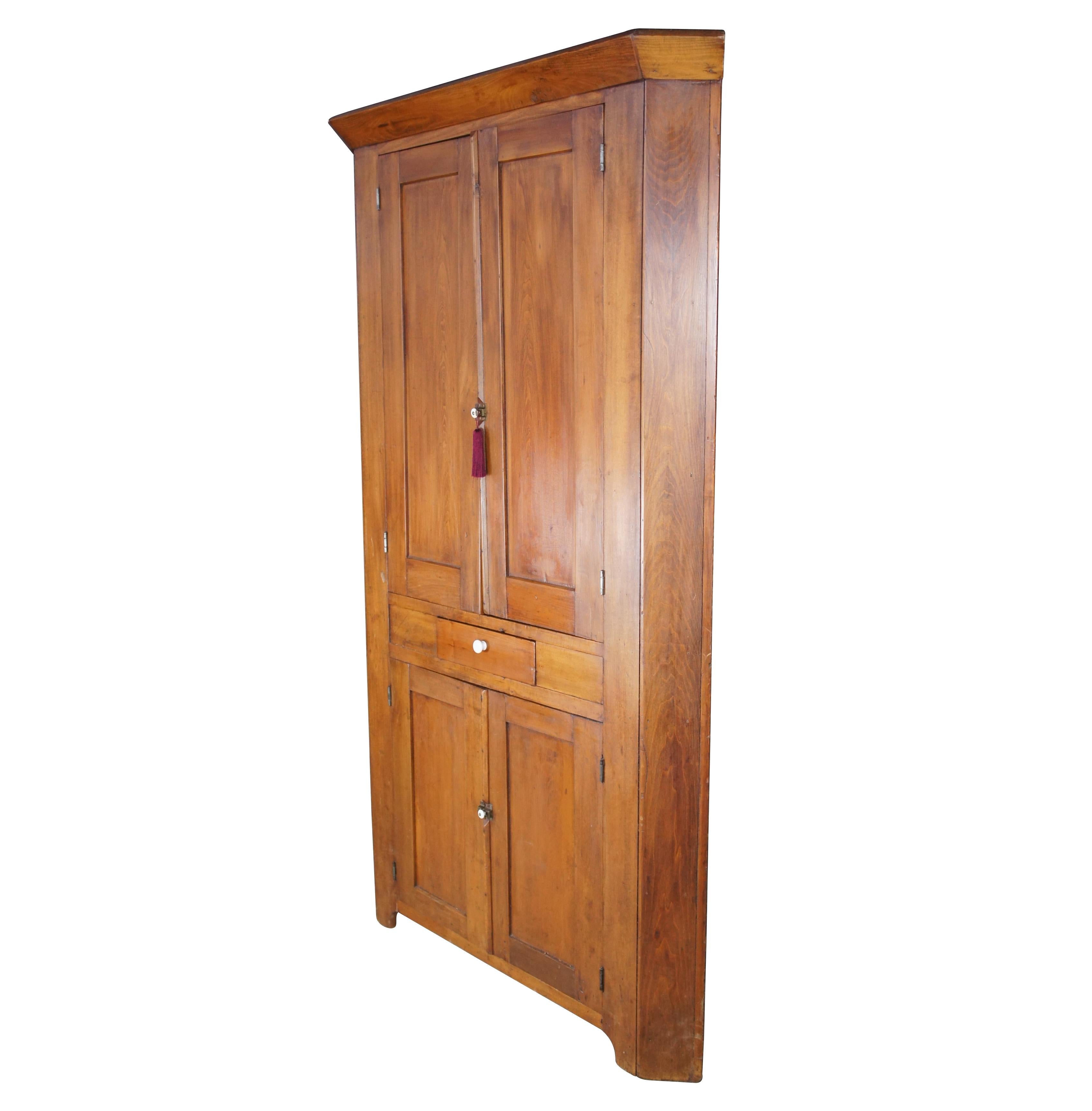 Primitive American corner cupboard, circa 1870s. Made from walnut and constructed using hand cut nails. Features a warm farmhouse patina with distressing from age. Hardware is iron and porcelain.

Measures: 51