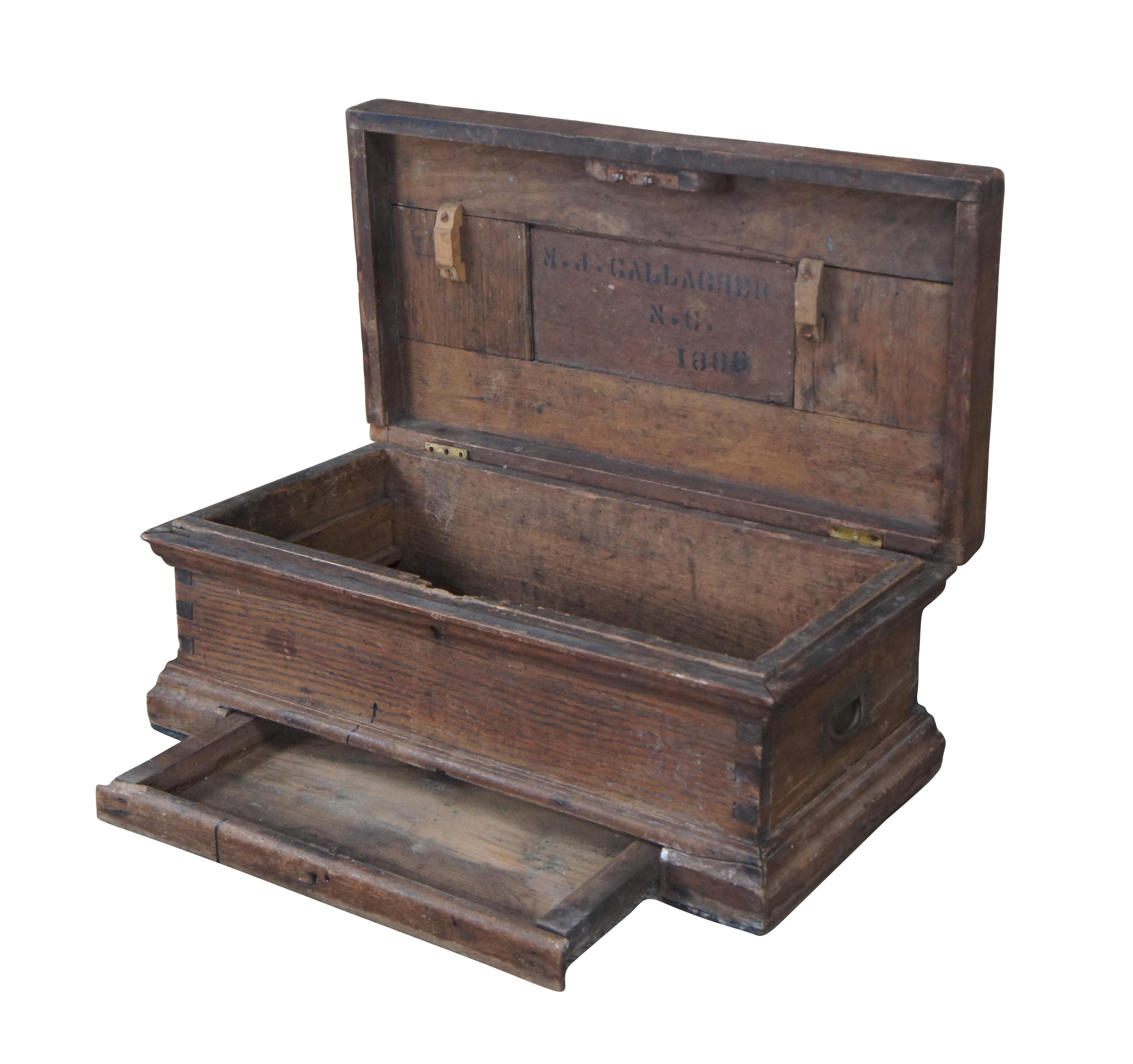 A charming late 19th century tool chest from M.J. Gallagher of North Carolina, Dated 1888. The trunk appears to be a carpenter or machinists trunk but could have also been used in military setting. Made from oak with finger-tailed construction.