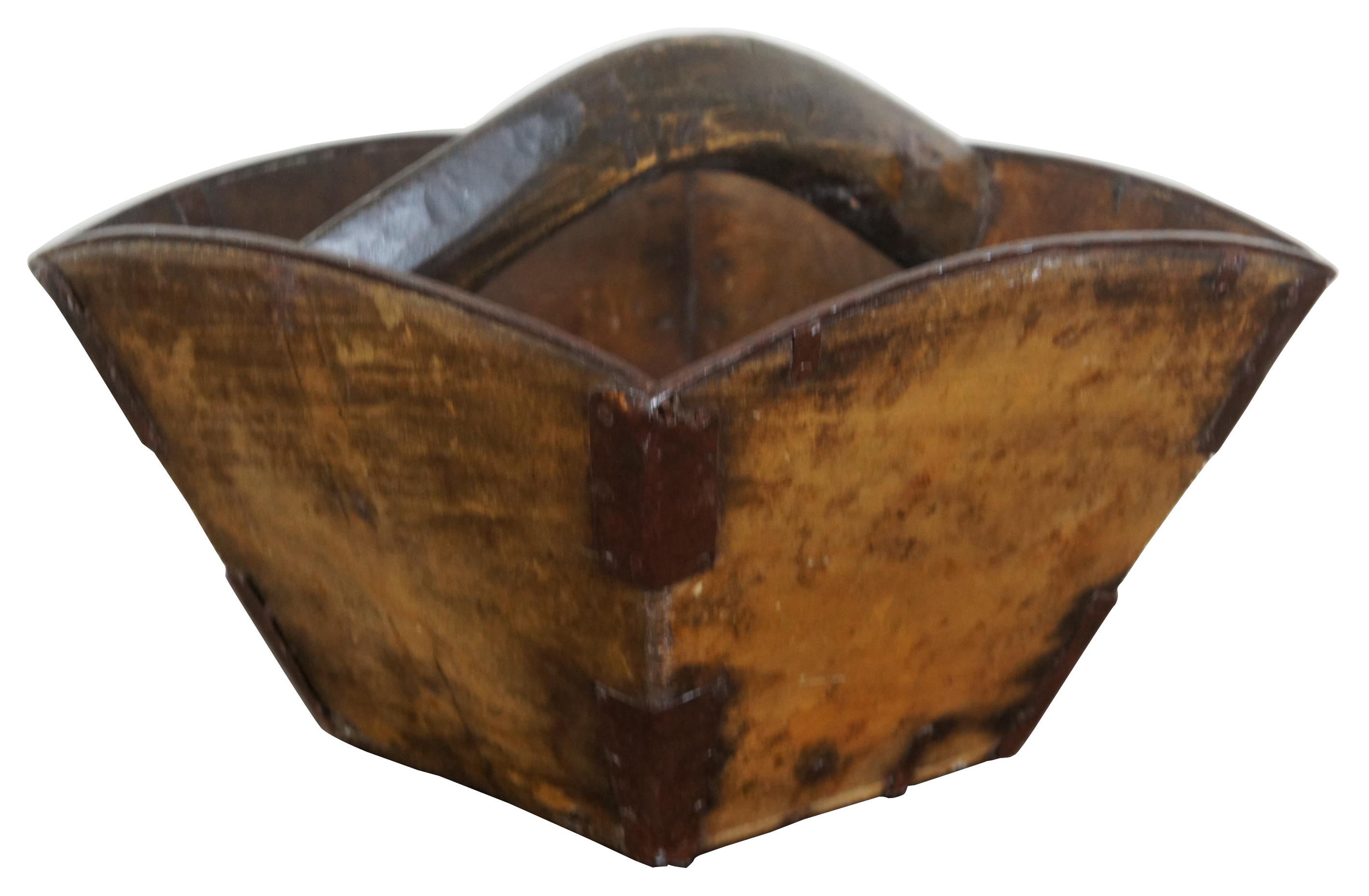 Antique Asian wooden rice bucket with metal reinforced corners, tapered square shape and handle across the middle. Measures: 13