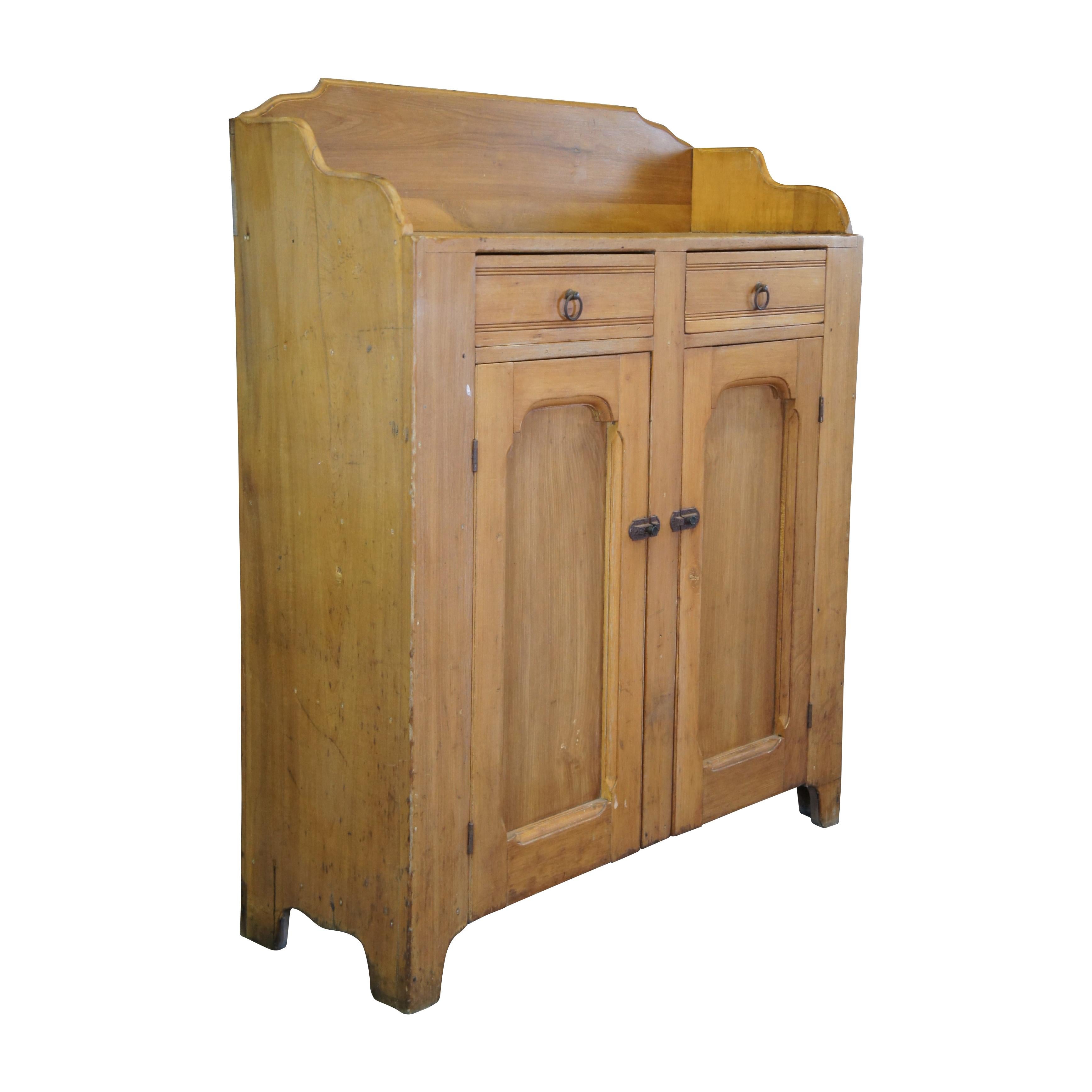 A warming handmade 19th Century Early American Jelly Cabinet or Pantry Cupboard, circa 1870s. A rectangular form made from Polar with an upper surface enclosed by a serpentine backsplash over two hand dovetailed drawers and lower cupboard with two