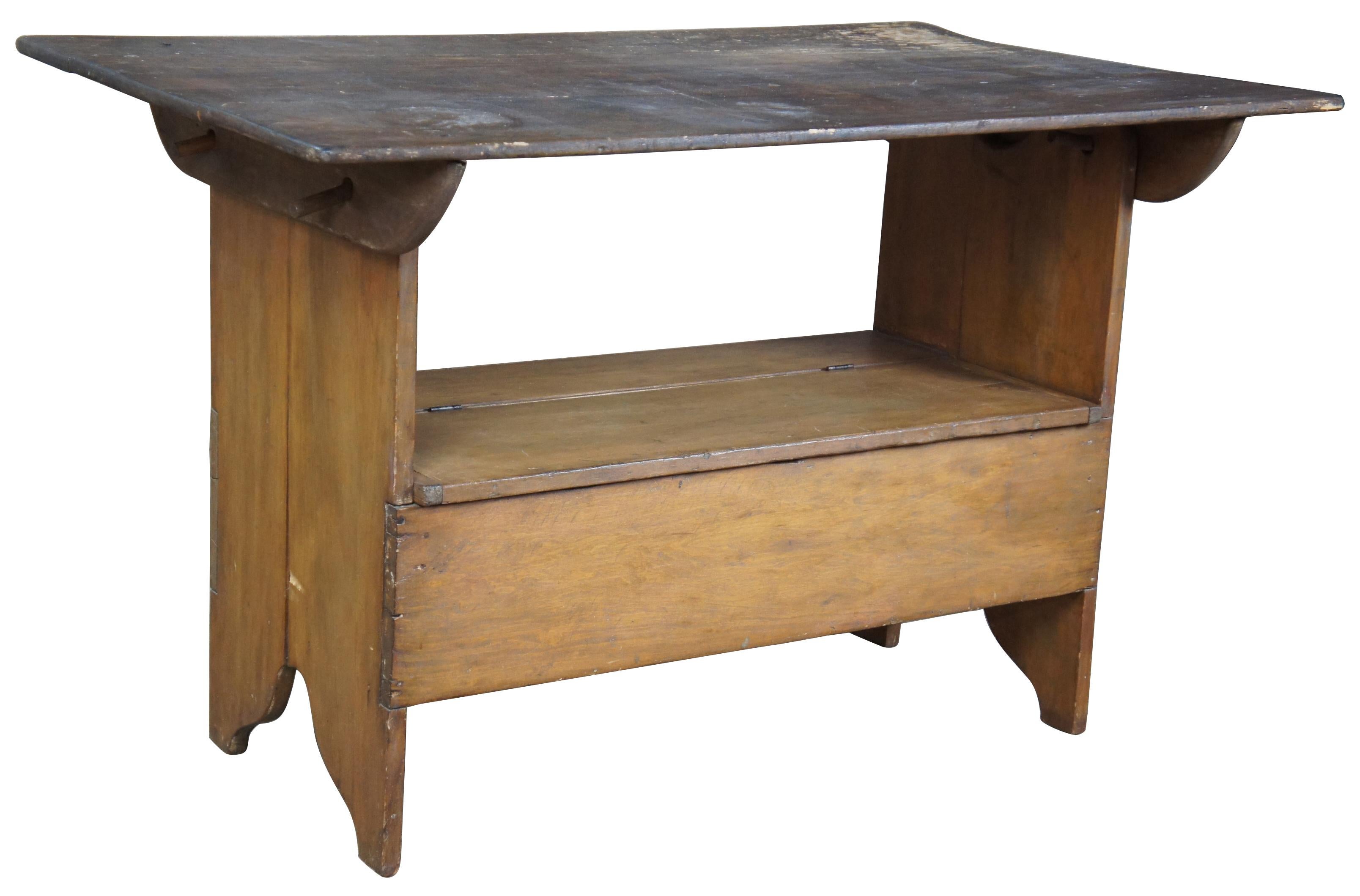 Late 19th century pine farmhouse convertable table slash bench. Features a lidded seat allowing for additional storage. Top is supported by four wooded dowels that slide easily into place.

Measures: Base 36