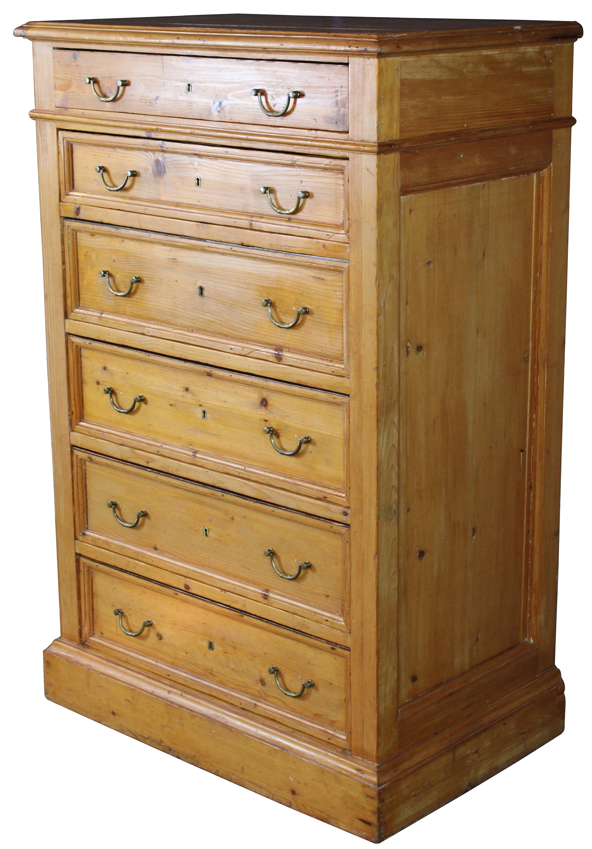 A stunning 19th century English tall chest of drawer or highboy. Made from pine with 6 lockable drawers and French brass hardware.
  