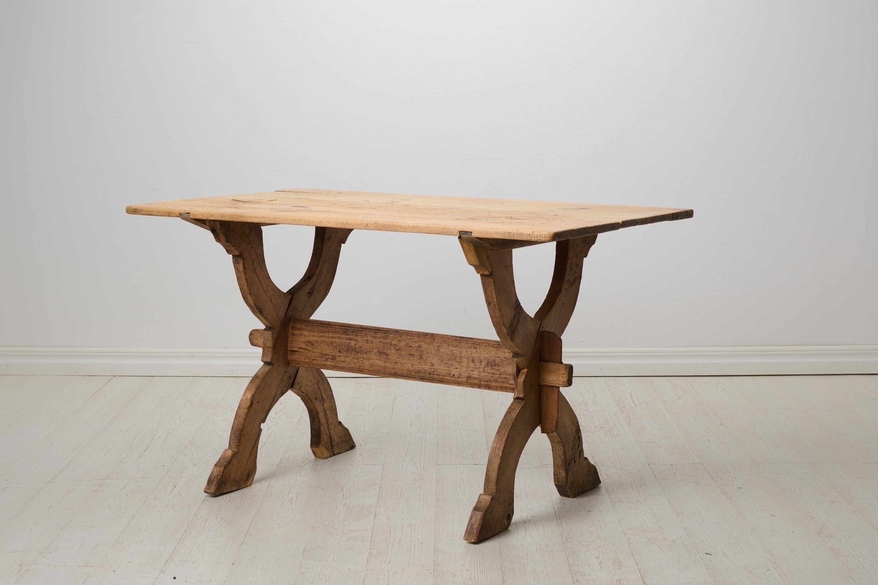 Table à tréteaux primitive du nord de la Suède, fabriquée à la main vers 1820 en pin massif. Le pin n'a jamais été peint, ce qui a permis d'obtenir une surface naturelle avec une patine et des traces après 200 ans d'utilisation. Notez la mesure de
