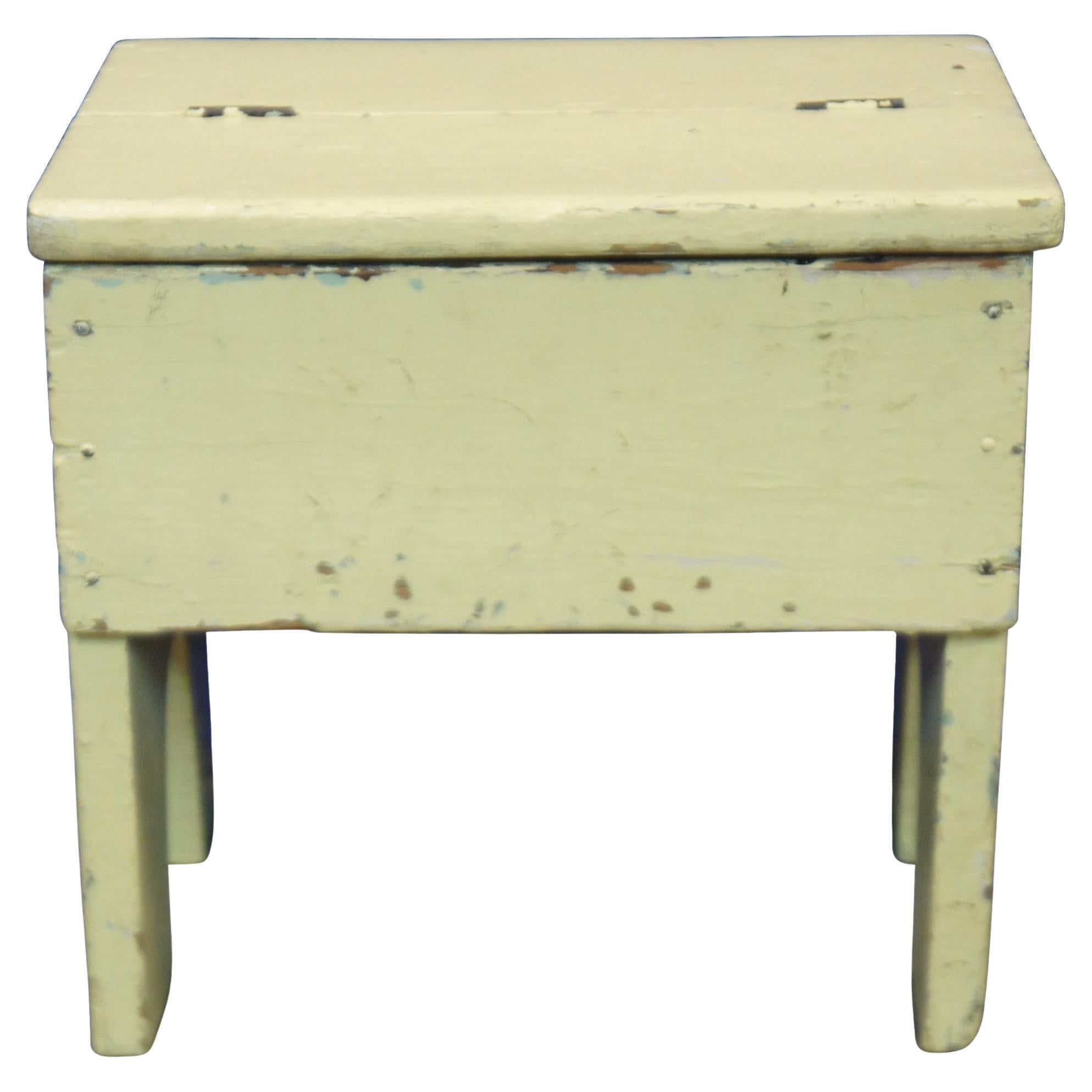 Antique wooden shoe shine box or step stool painted in pale yellow gloss.
 