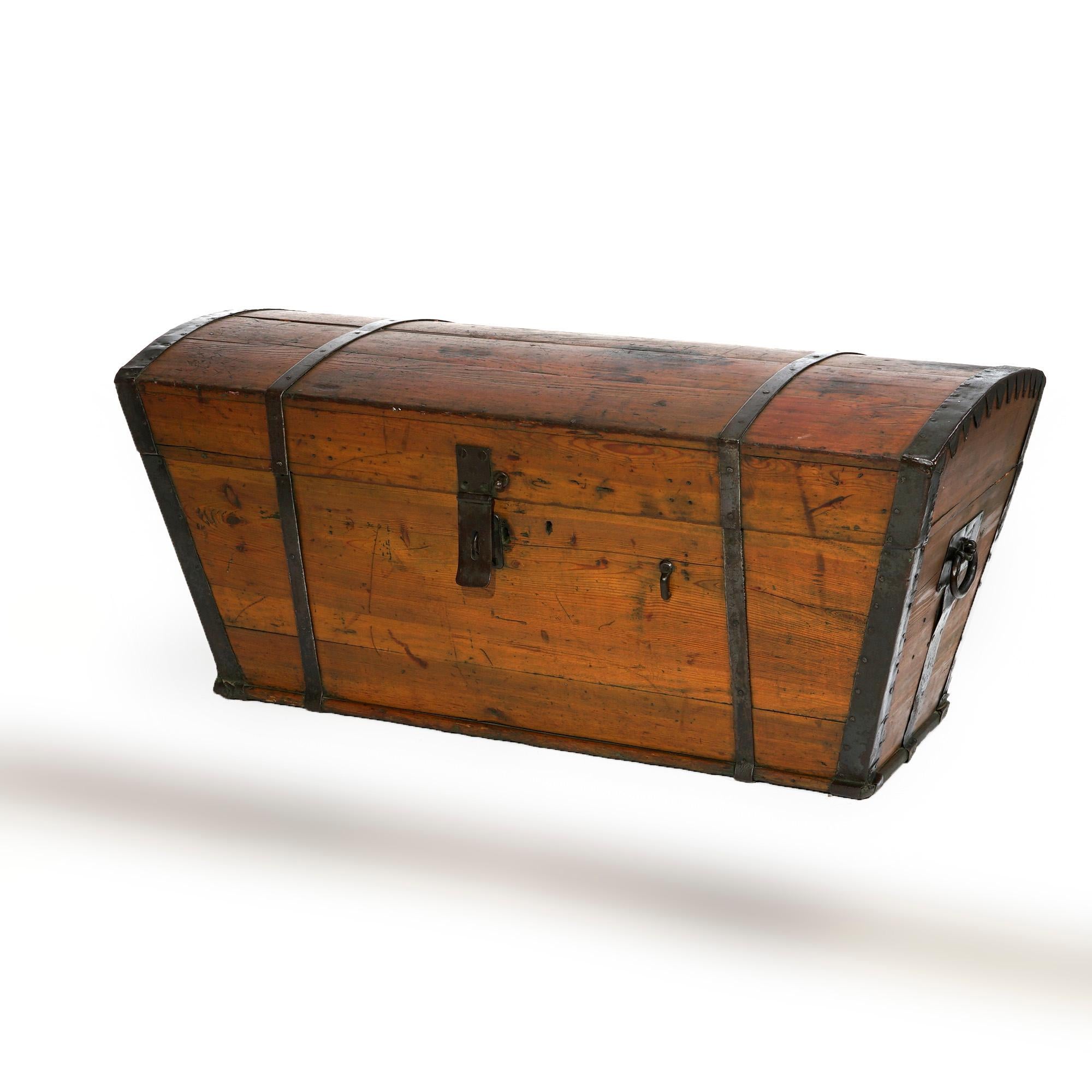 An antique Western American Conestoga wagon blanket chest offers wood construction with domed top trunk lid and tapered sides with iron straps and hinges, 19th century

Measures- 21.5'' H x 47'' W x 22'' D.

Catalogue Note: Ask about DISCOUNTED