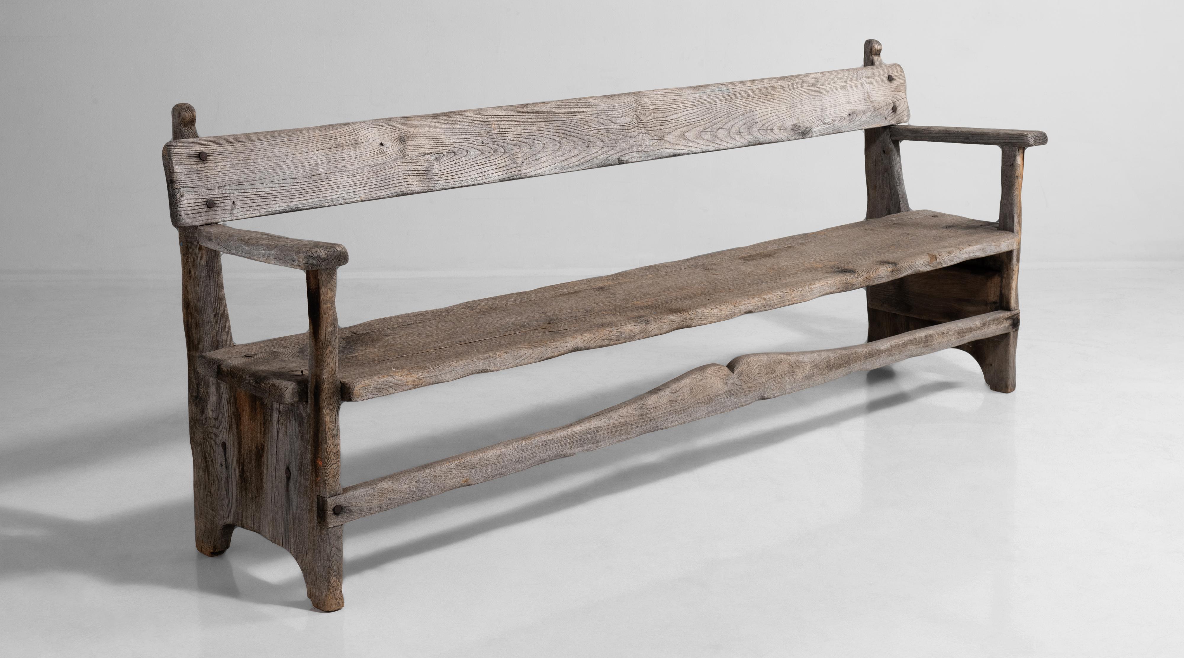Weathered bench constructed in teak.
  