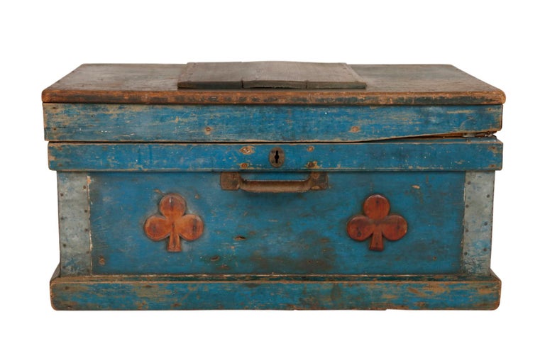 An antique primitive style blanket chest painted in a rich Giverny blue, popular in early 20th Century interiors and named after the village in Northern France where Claude Monet lived. The chest is decorated in front with two trefle appliques.