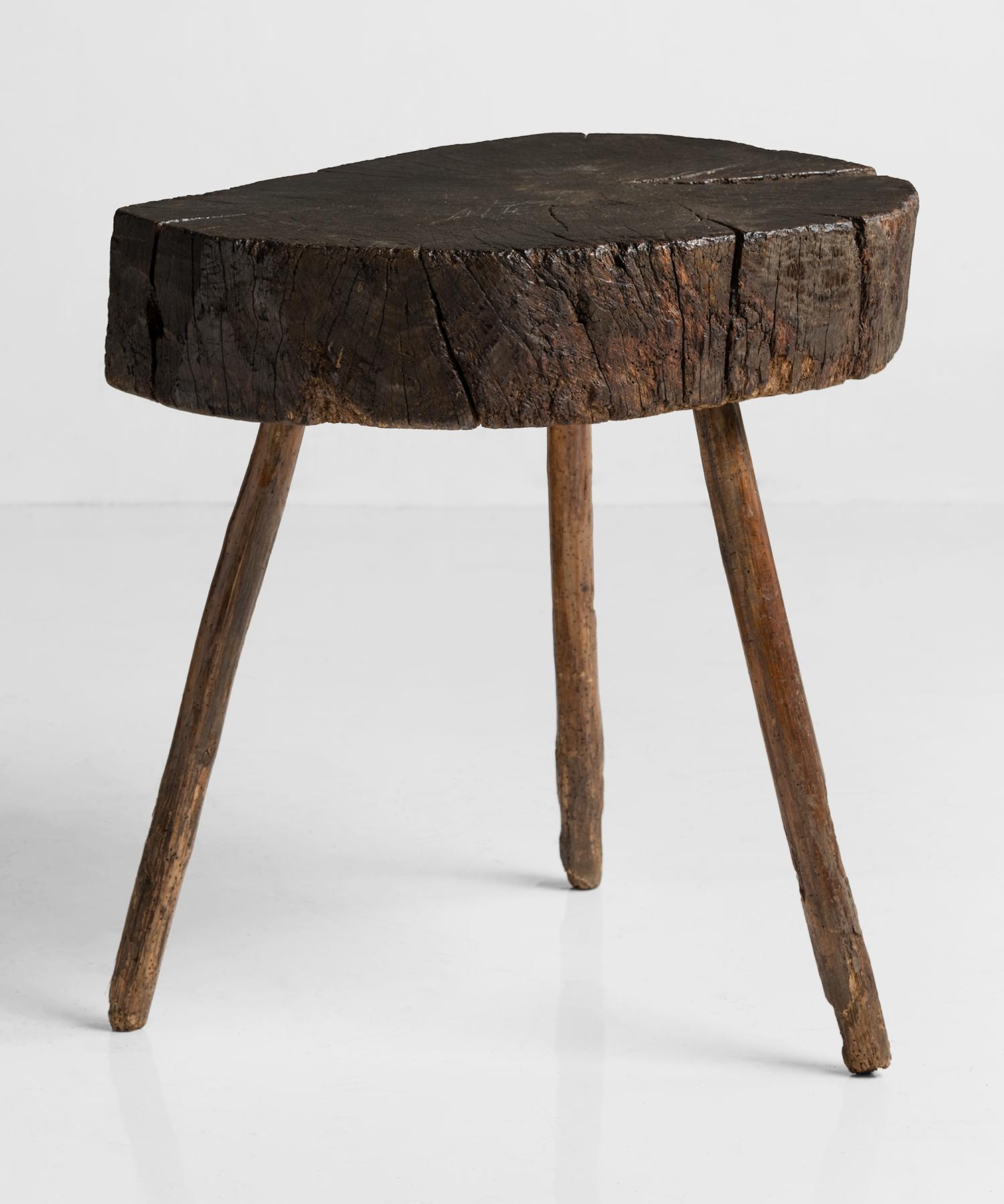 Primitive butcher block table, England, circa 1900

Asymmetrical single slab varnished top on three peg legs with amazing patina.
