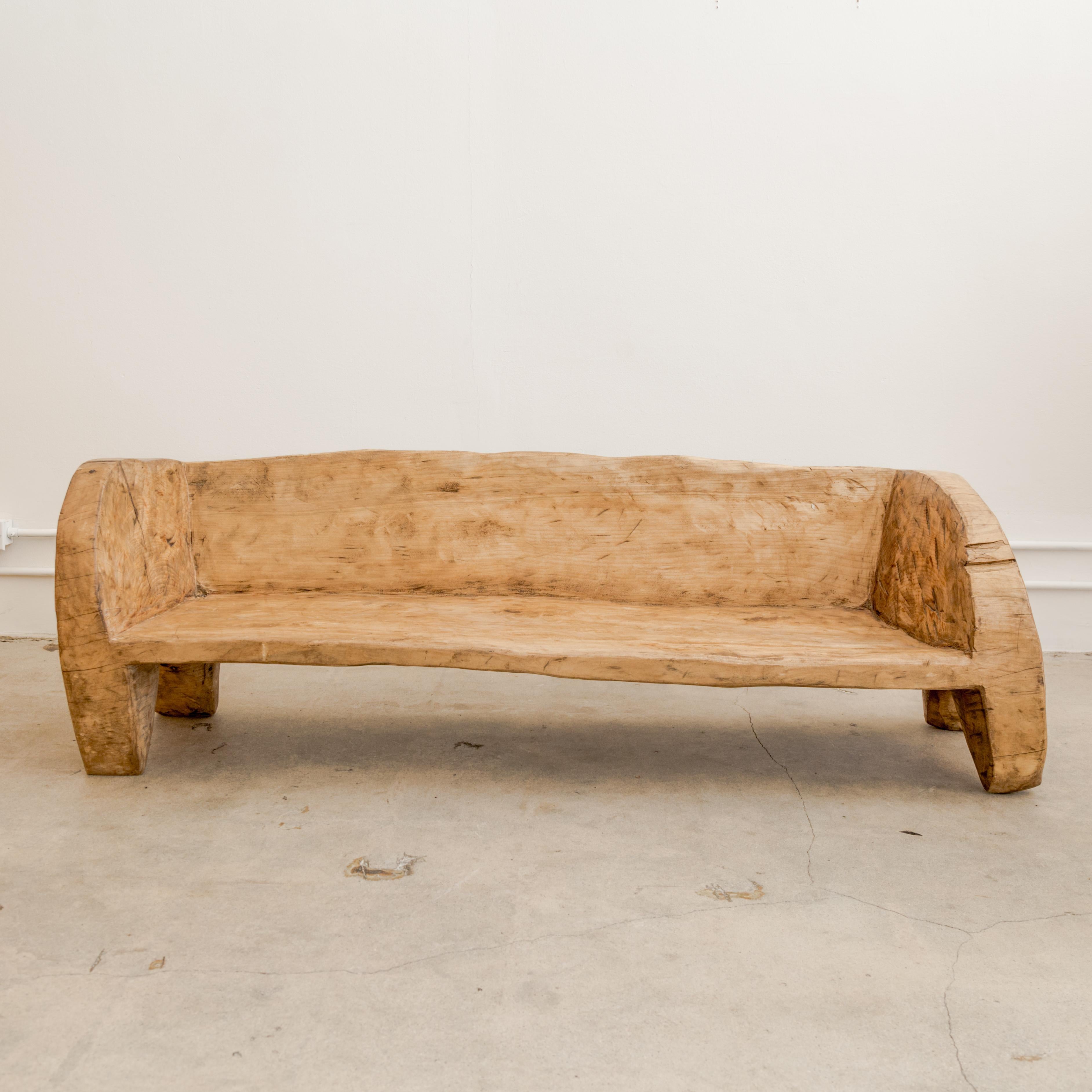 Primitive bench carved from single timber, Indian, contemporary.
