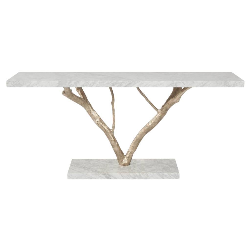 Nature’s forms, materials and textures are immortalized in striking fashion in this piece. The structure is molded in brass casting from magnolia tree branches, providing function to its natural form. The marble base and top deepens the piece’s
