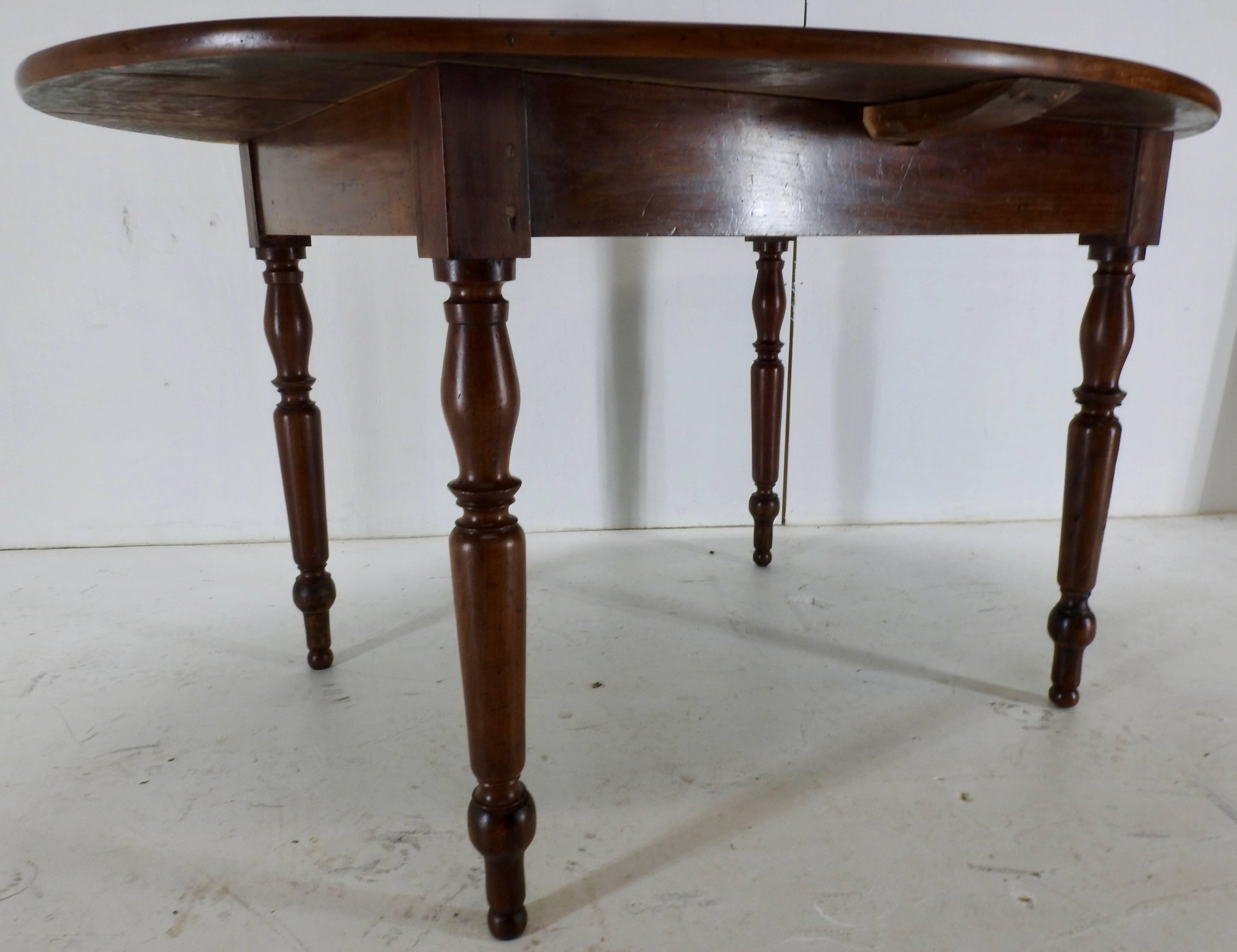 Offering this mid-19th century cherrywood dinette table in an oval shape. Has nicely turned legs and a metal crossbar underneath for support. The warm grain to this table makes for beautiful lines. The craftsmanship is absolutely stunning with many