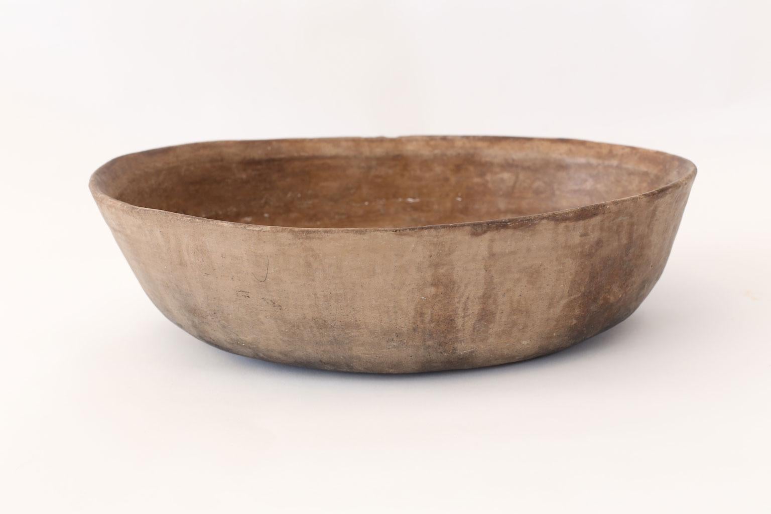 Primitive clay cooking bowl from Los Reyes Metzontla, Mexico. This vintage vessel is hand-sculpted, created and used circa 1950 by the indigenous population of the isolated Mexican highlands of Puebla (Zapotitlán). Exhibiting a nice rich patina,