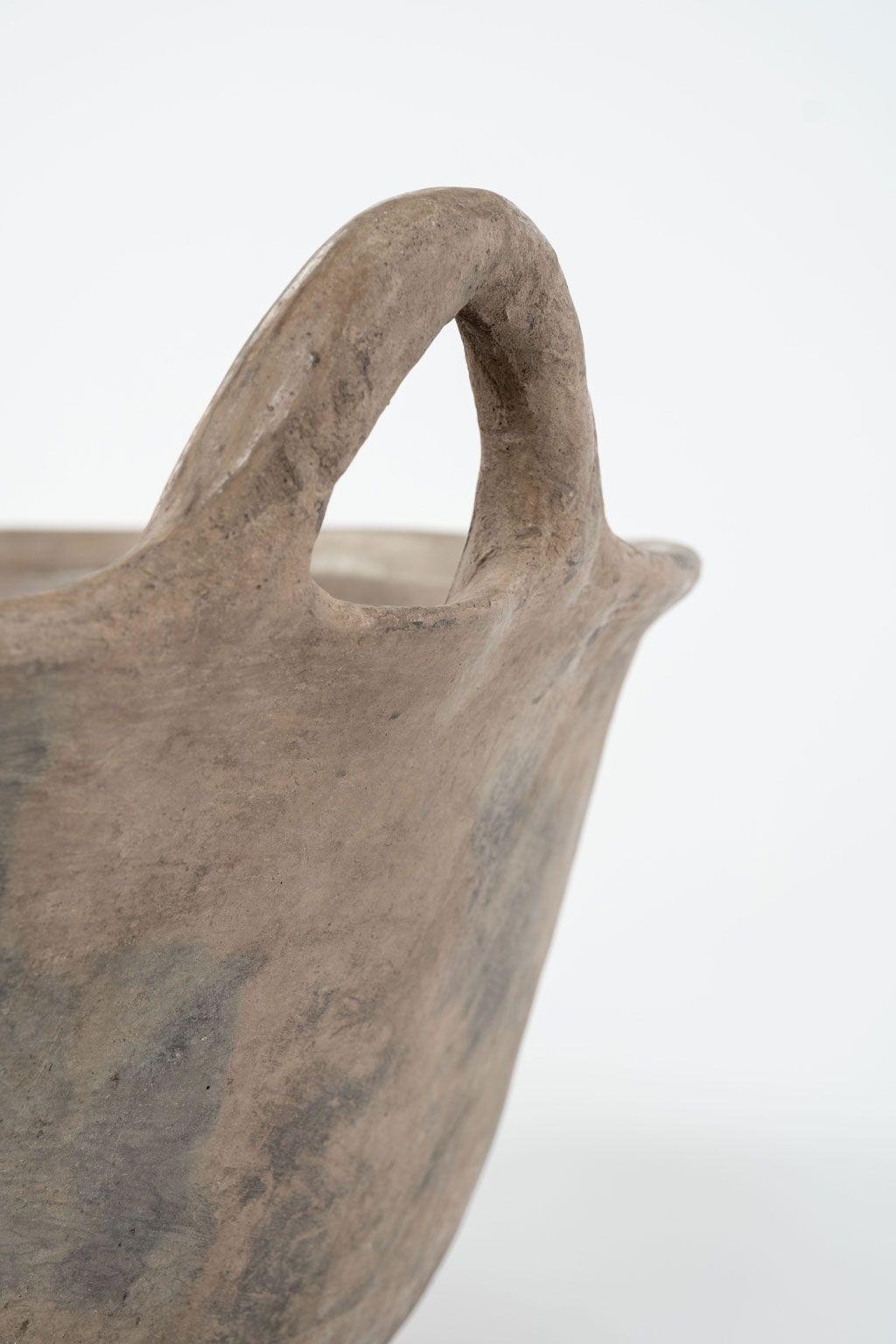 Primitive clay cooking bowl from Los Reyes Metzontla, Mexico. This vintage vessel is hand-sculpted, created and used circa 1950-1969 by the indigenous population of the isolated Mexican highlands of Puebla (Zapotitlán). Exhibiting a nice rich
