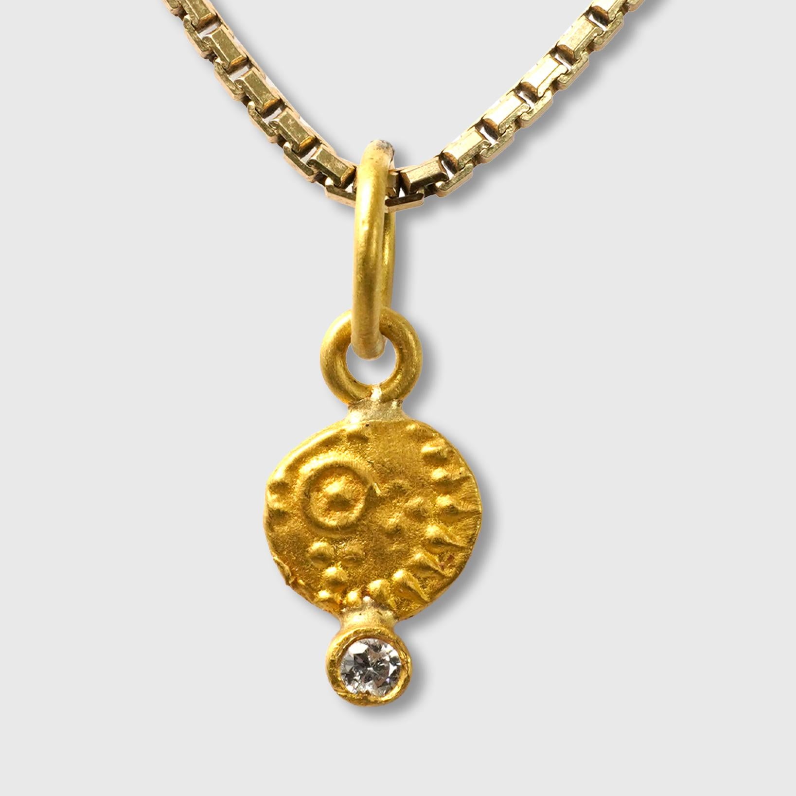 Primitive Coin Charm, Solid 24K Gold and 0.02ct Diamond

Size - Very Small Charm (Looks great paired and layered with other charm pendants)
1 Diamond - 0.02cts
24K Solid Gold - 0.97 grams

THE STORY

Wealth and prosperity: in many cultures, coin