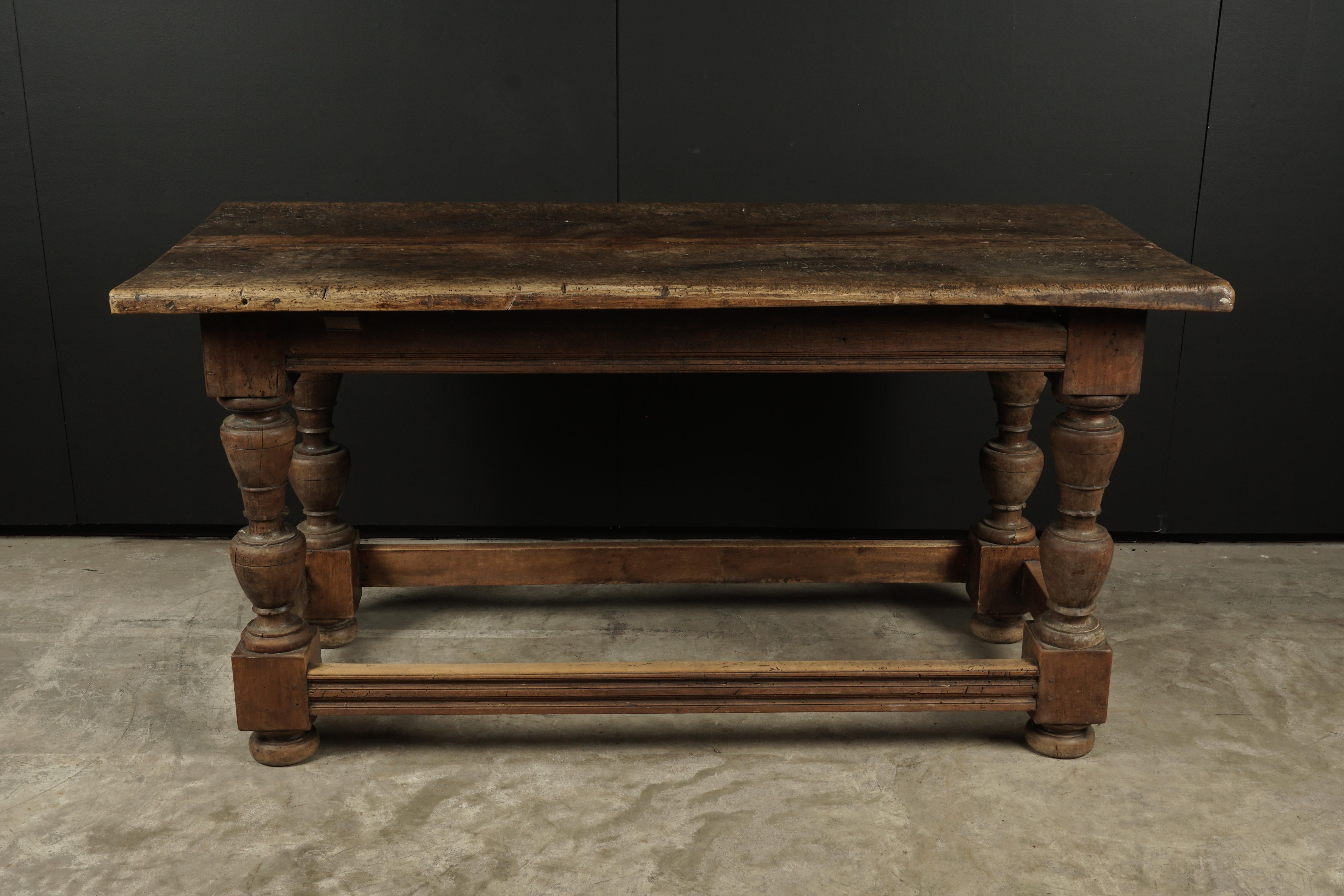 Primitive console table from France, circa 1850. Solid walnut top with nice wear and patina.