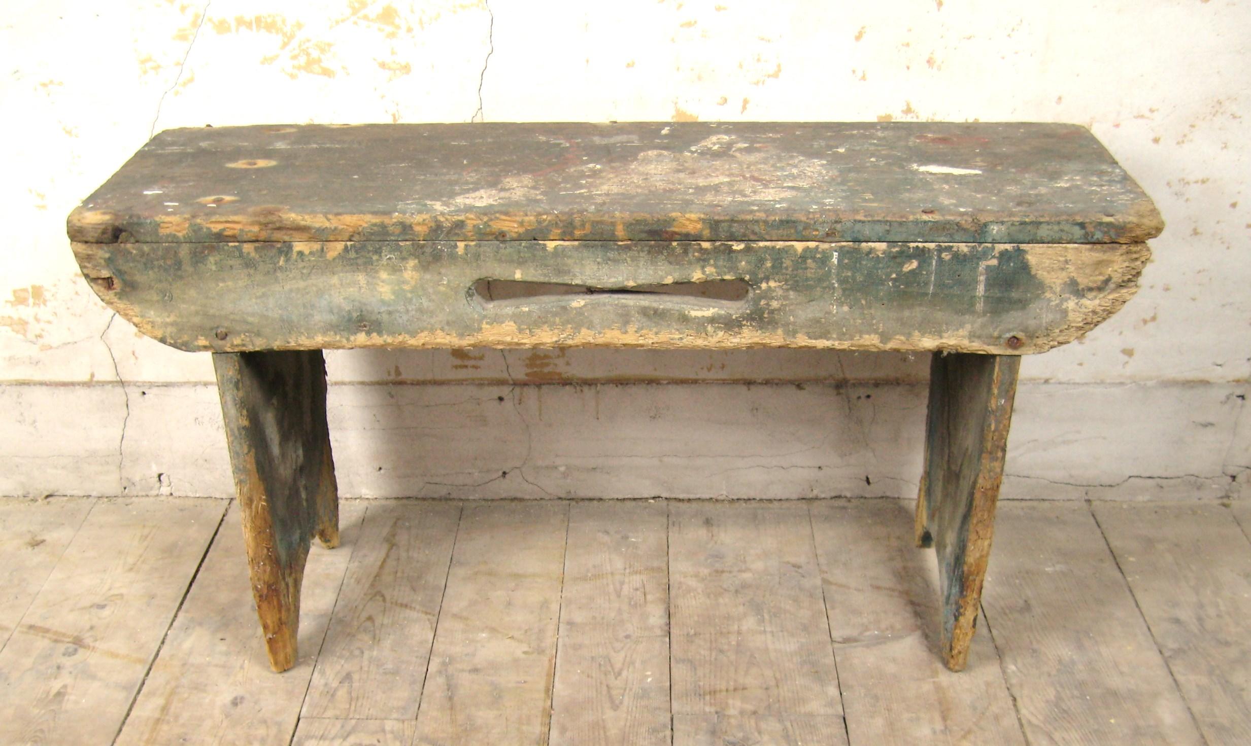 1930's Original Barn Bench with original paint that has not been touched in many years. Please look at the photos, it has an unusual cut out and boot jack feet. It also has remnants of many many years of work in someone’s barn. Has paint splatter,