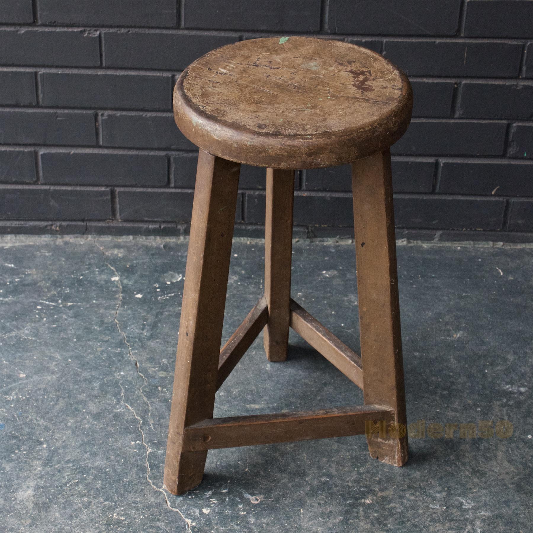 Wonderful and heavy Hardwood, like chestnut stool. Has an Arts and Crafts era feel. Tight Joinery. Original paint and finish. Seat top is 10 1/2 inch in diameter, and the leg splay is about 14 in diameter. Earthy brown color.