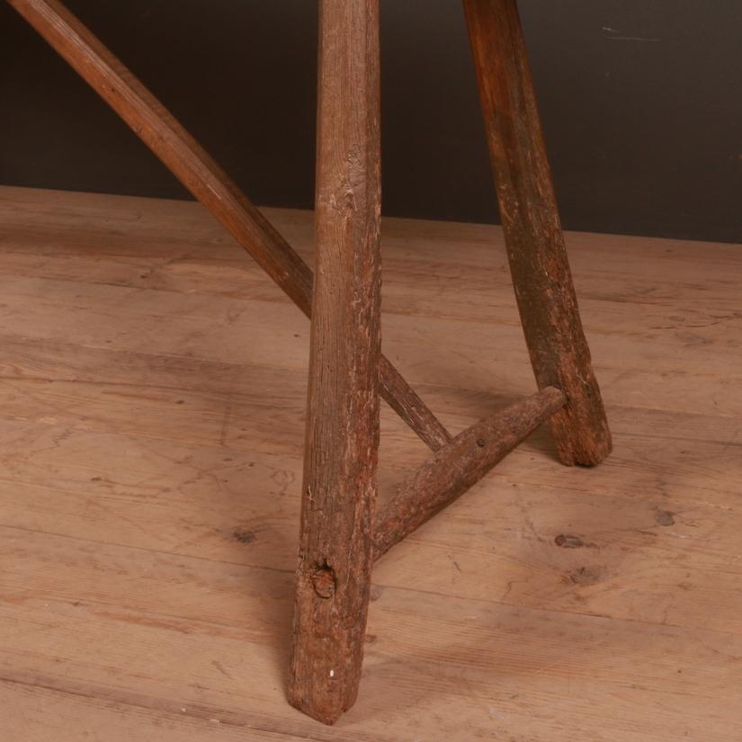 Narrow 19th century primitive French Elm trestle table. The top is 14
