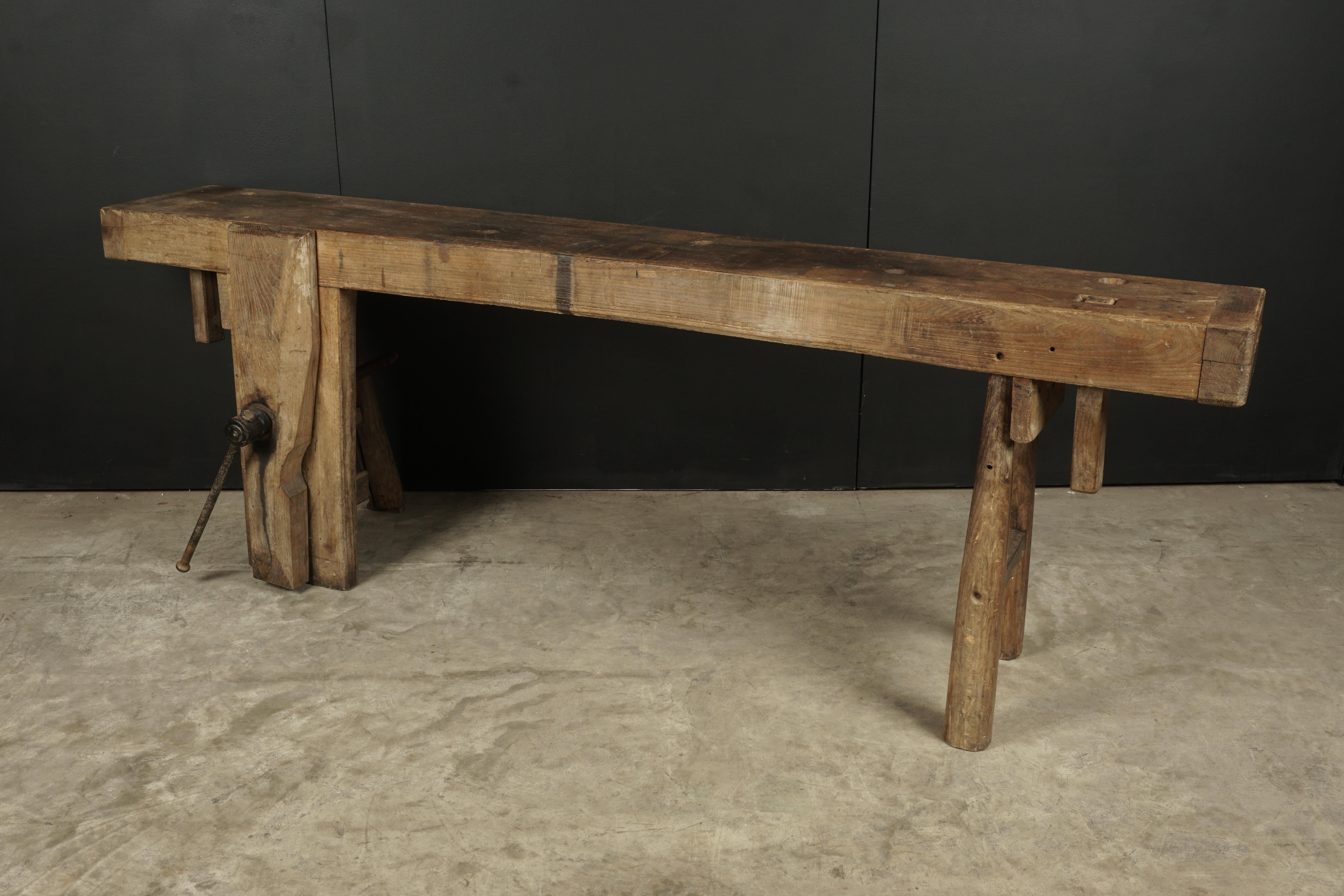 Large Primitive French work console, circa 1900. Rare and naive model with solid round legs. Thick solid oak construction with original clamp.