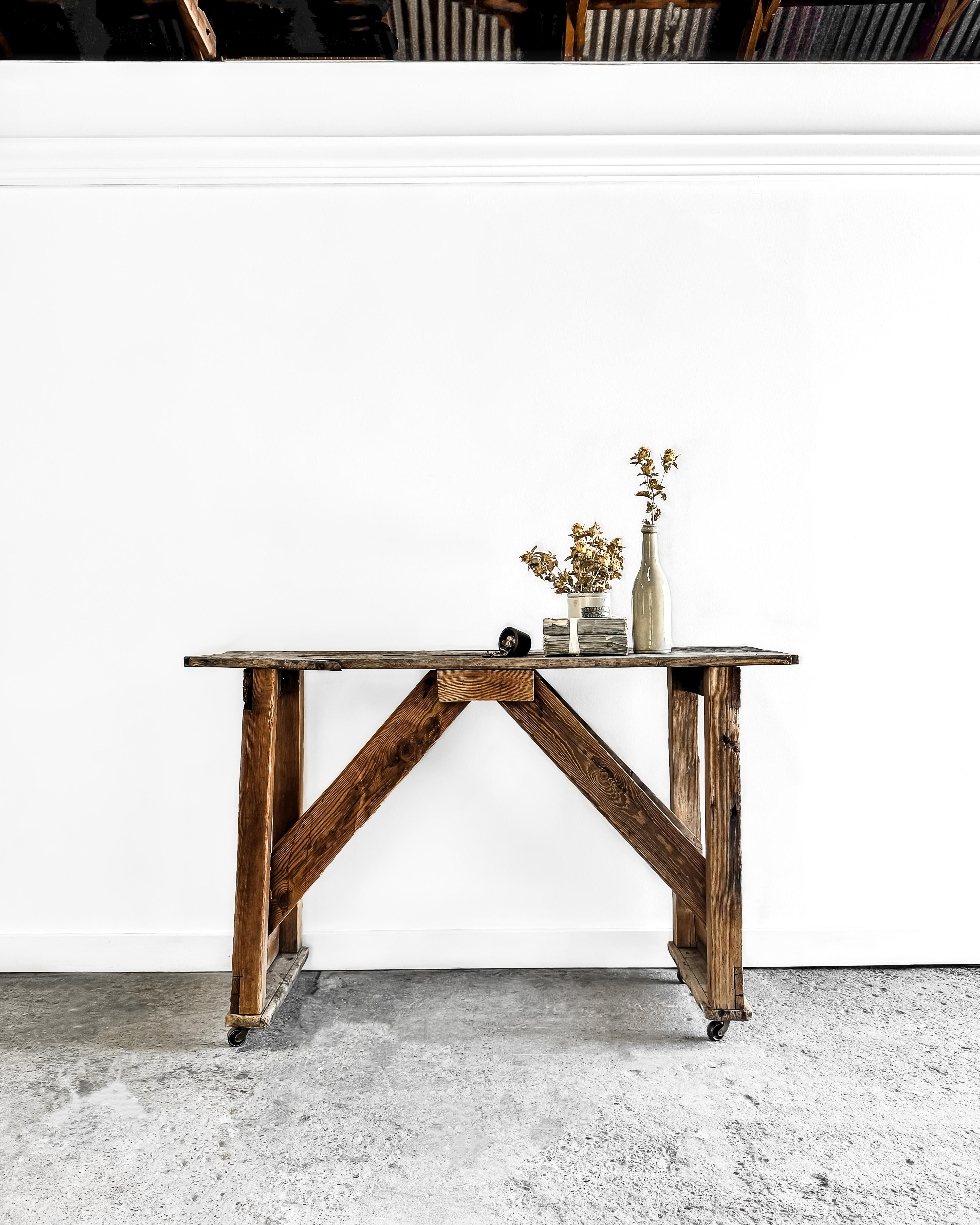 This old workshop table, with its straightforward, clean lines and planked top, is the perfect addition to a modern home. Weathered over time with a great patina, its character marks lend charm and tell a unique story. 

This versatile and