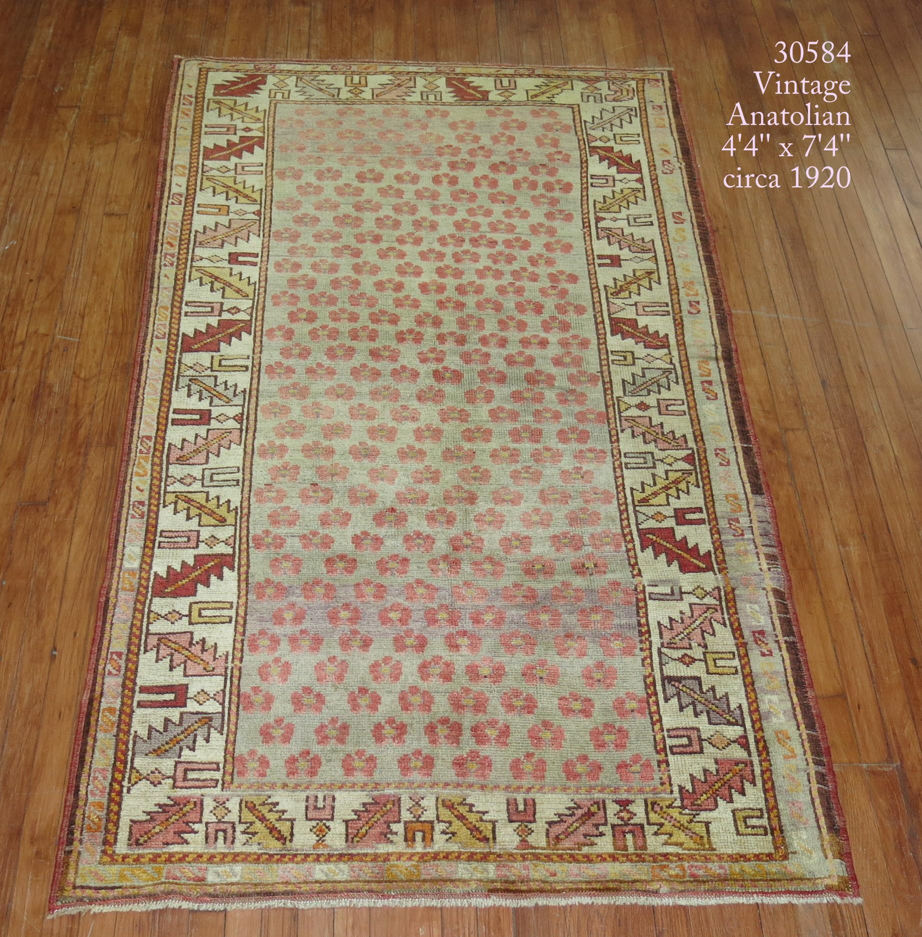 One of a kind decorative vintage Turkish Anatolian rug with a small repetitive floral design on a gray color ground.

Measures: 4'4