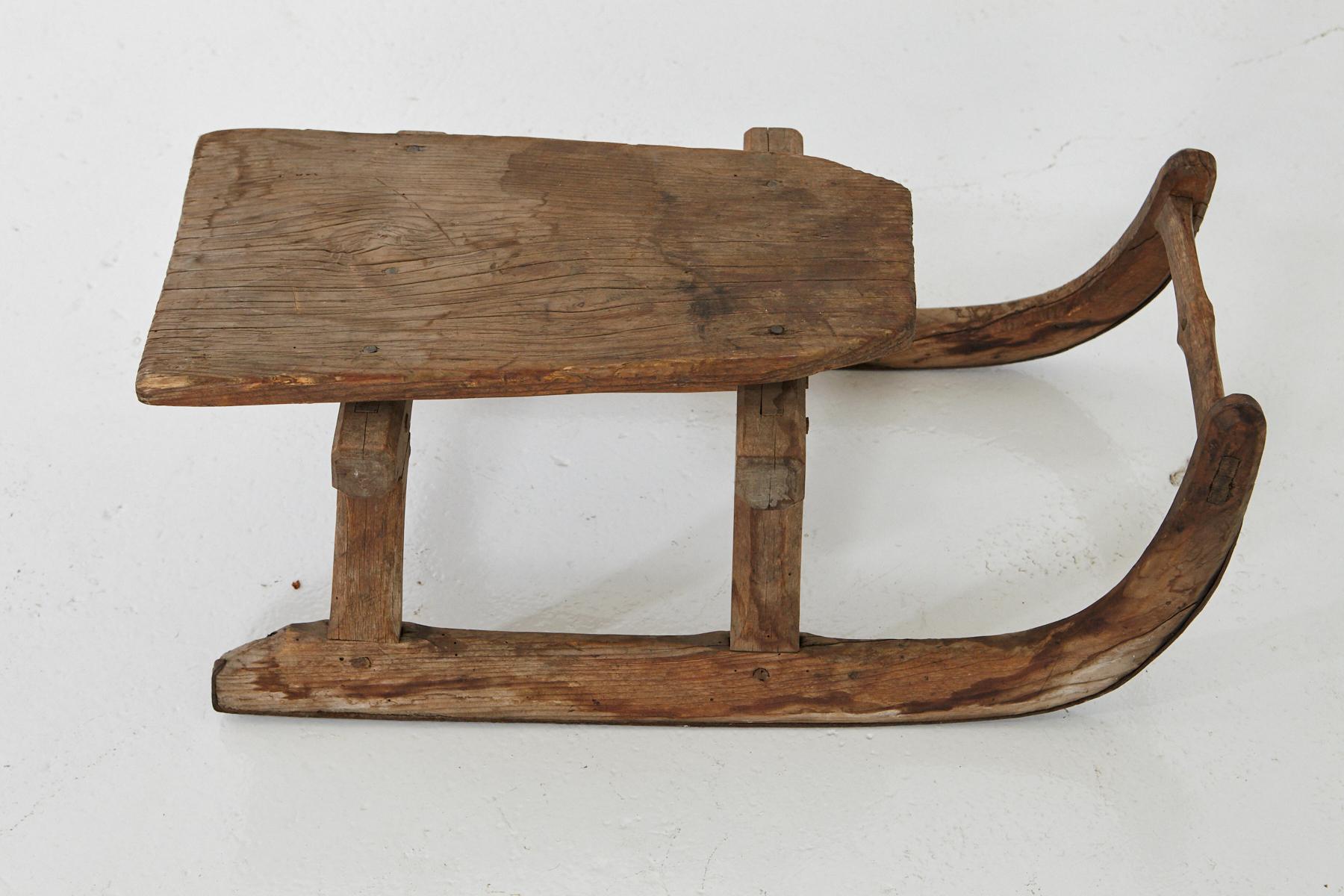 Lovely hand carved primitive, puristic wooden sleigh for one person, probably end of the19th century.
The sleigh has a beautiful, silverish weathered patina.
Very solid and sturdy construction, still usable.