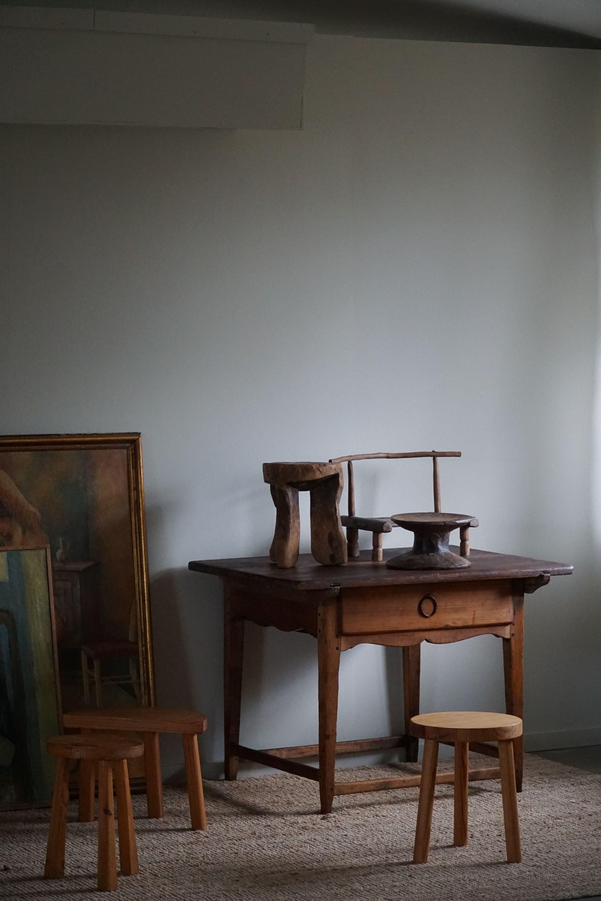 This primitive desk, hailing from 19th-century Sweden, reflects the rustic charm and simplicity of traditional craftsmanship. Meticulously crafted in pine wood, the desk showcases the skill of a Swedish carpenter who carefully carved and assembled