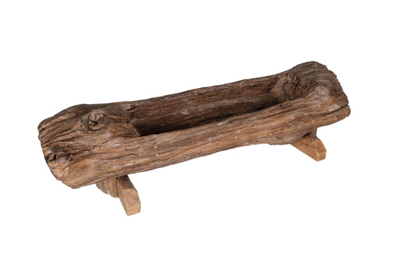 An organic hand-hewn wooden trough with two-legged base.

The piece is a part of our one-of-a-kind collection, Le Monde. Exclusive to Brendan Bass. 

Globally curated by Brendan Bass, Le Monde furniture and accessories offer modern sensibility,