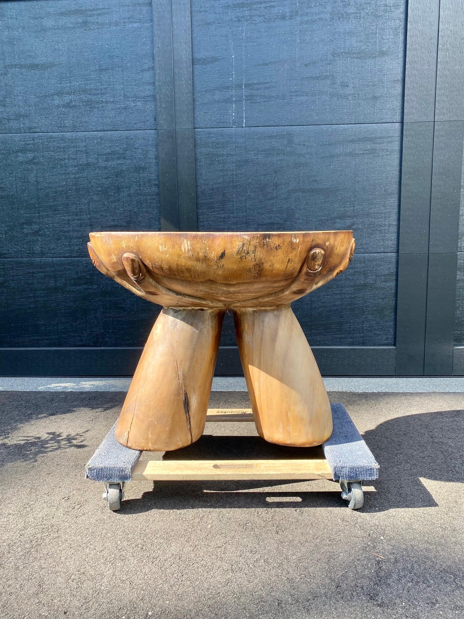 A stunning, handmade wooden accent table made from a single tree stump fashioned into a hand motif. An excellent piece of primitive work showing true craftsmanship -- a one-of-a-kind piece to own.
