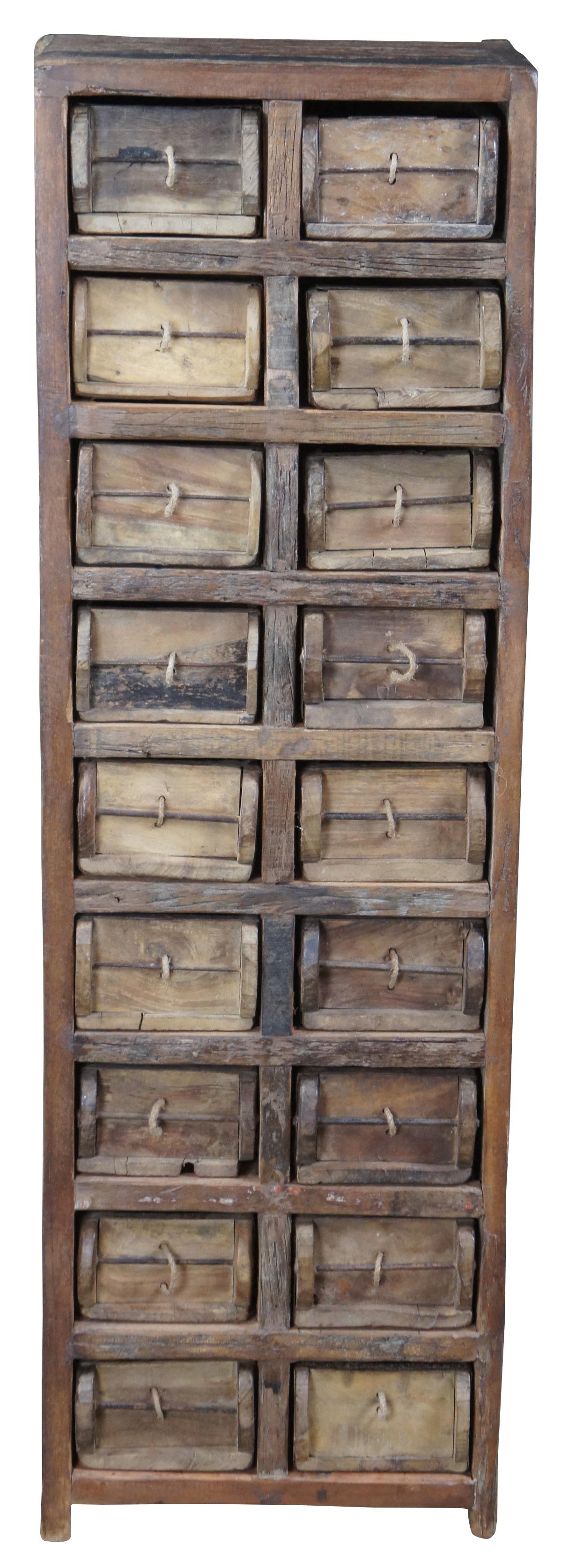 20th century rustic 18 drawer apothecary cabinet. Made from heavy wood with iron accented drawers featuring a unique rope pull design.